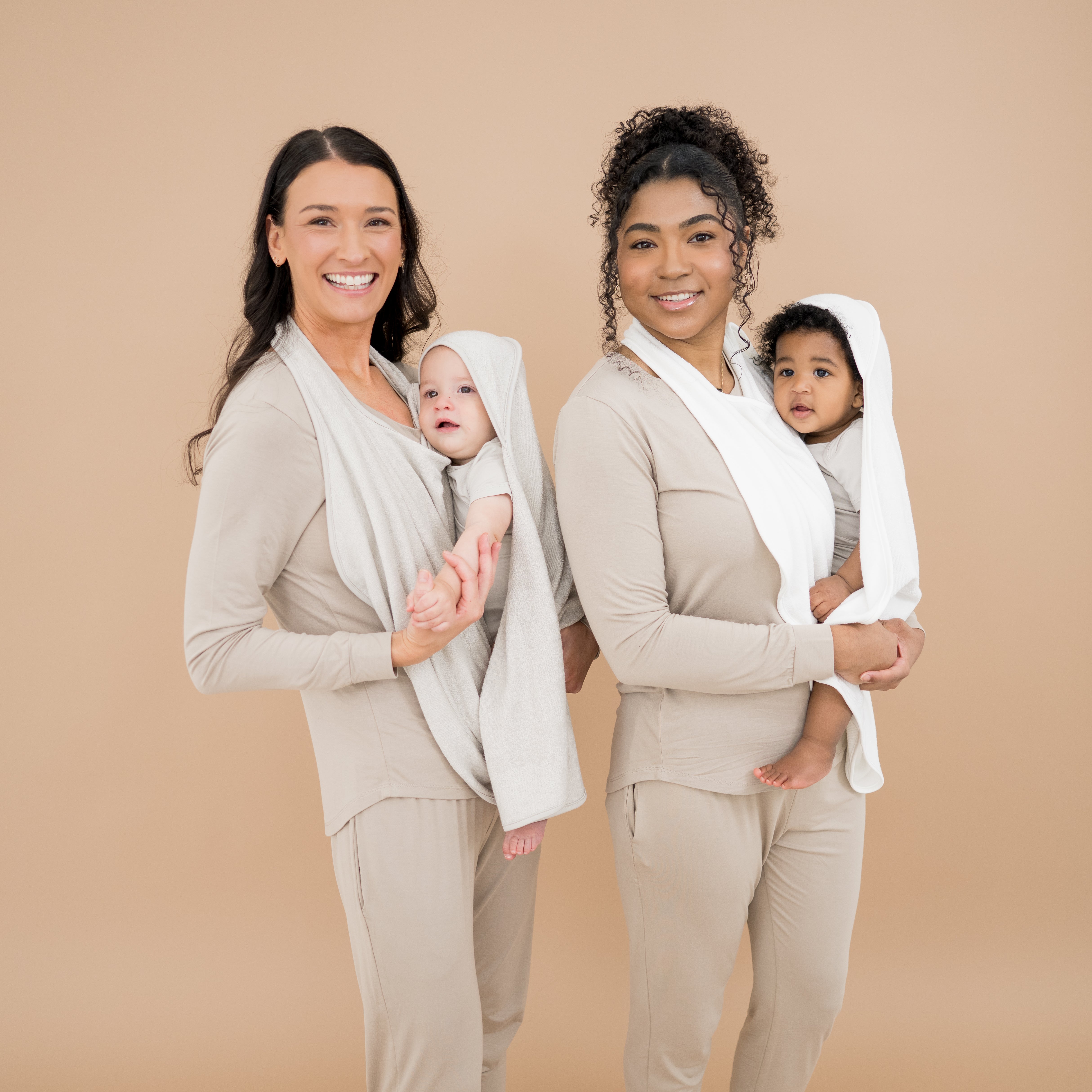 Mothers using Terry Apron Towels to wrap their babies after bathtime