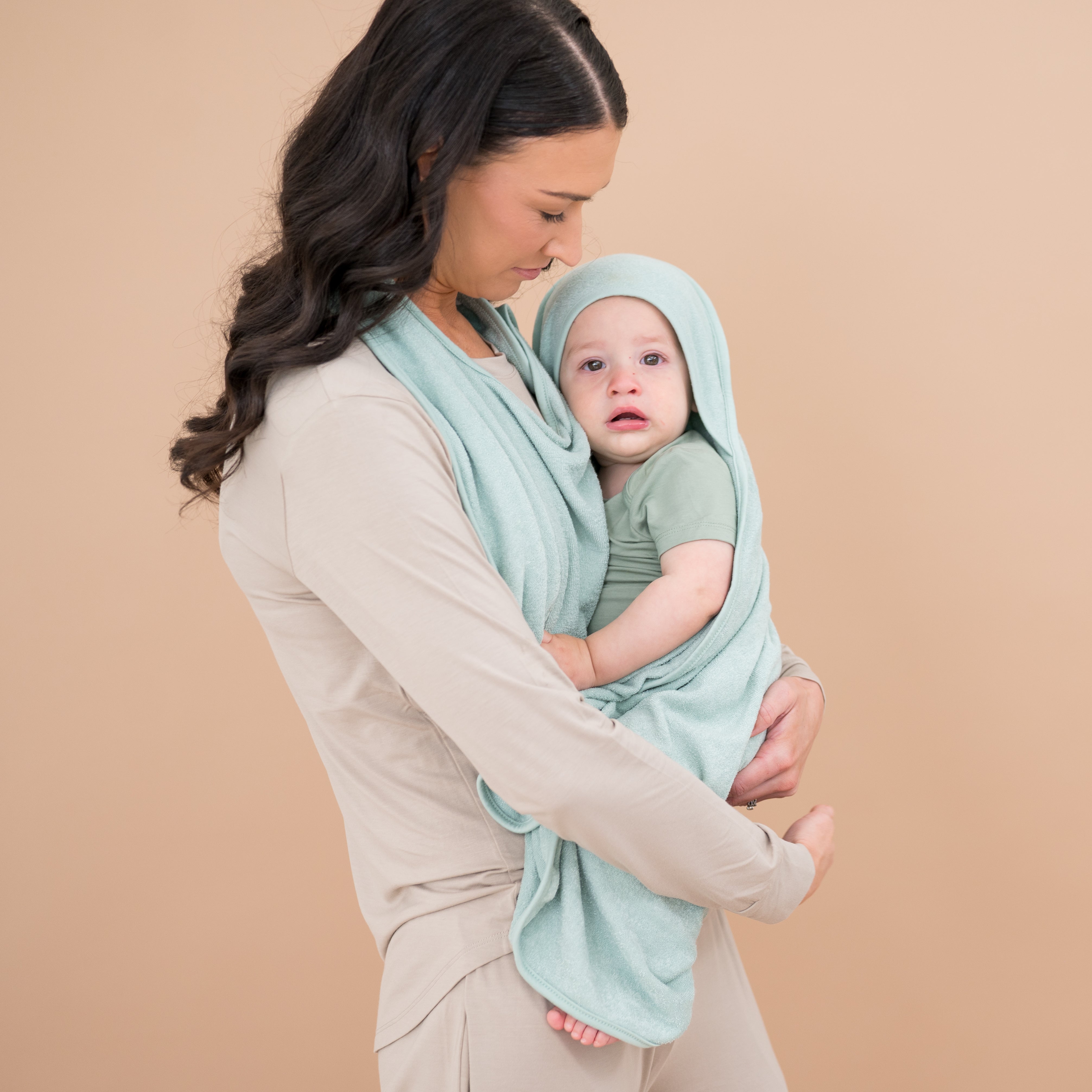 Mom holding baby in Bamboo Terry Apron Towel in Sage
