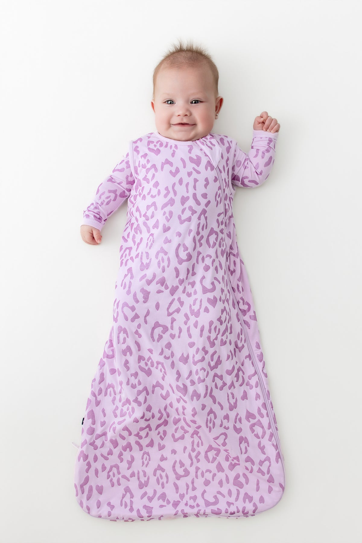 Baby in sleep bag in Thistle Leopard print on a white background