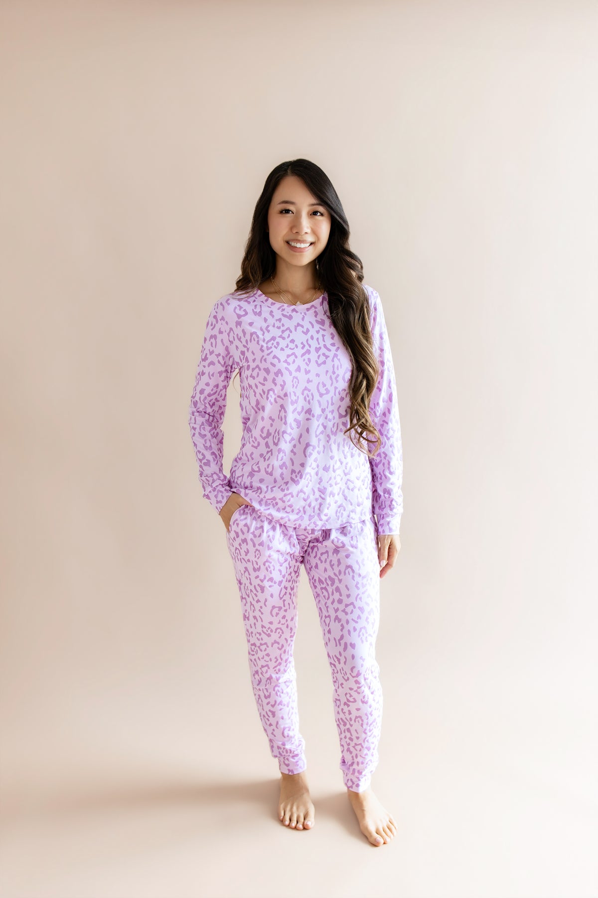 Model wearing Women's Jogger pajama set in Thistle Leopard print on a beige background