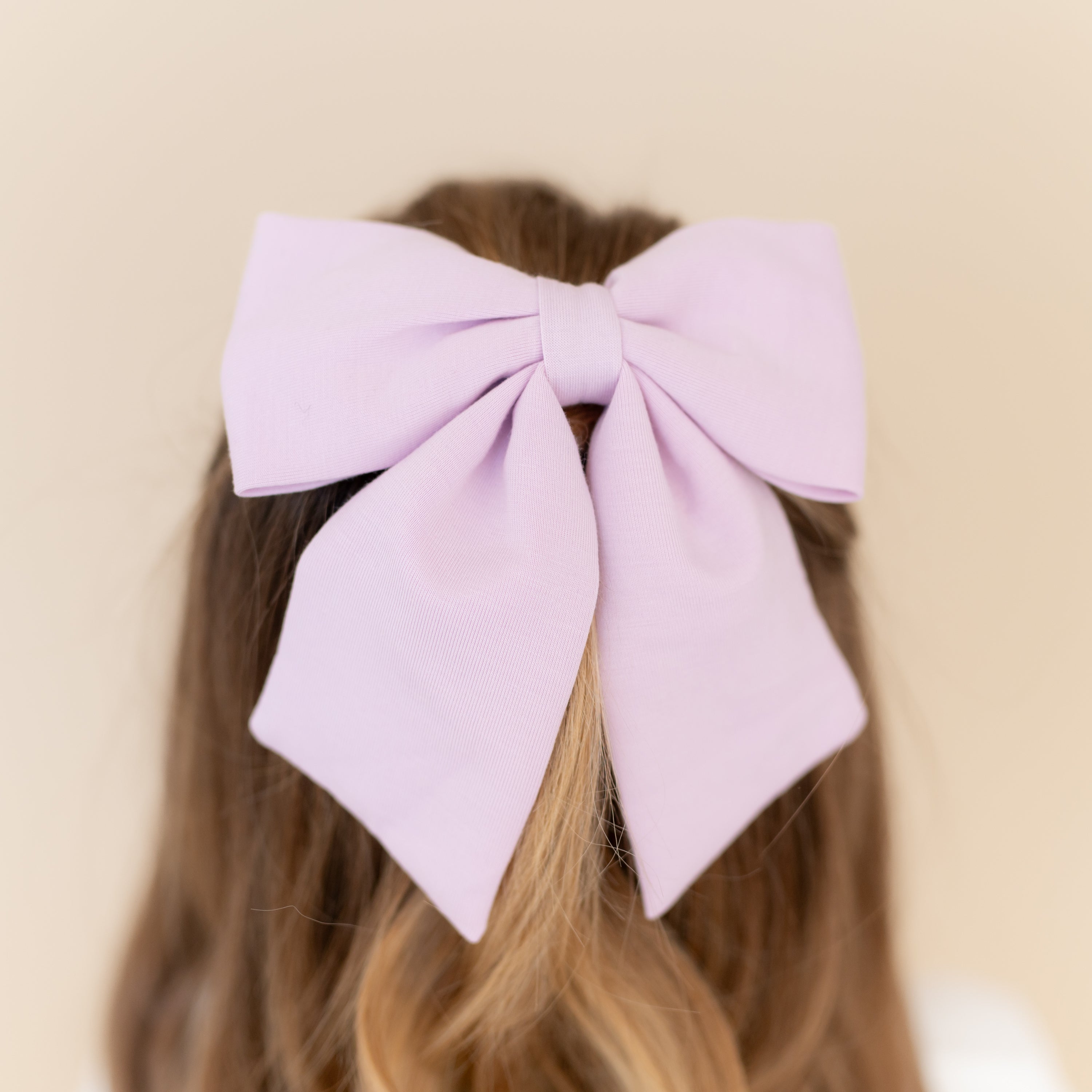 Close up of the Large Alligator Clip Bow in Thistle shown in a young girls hair