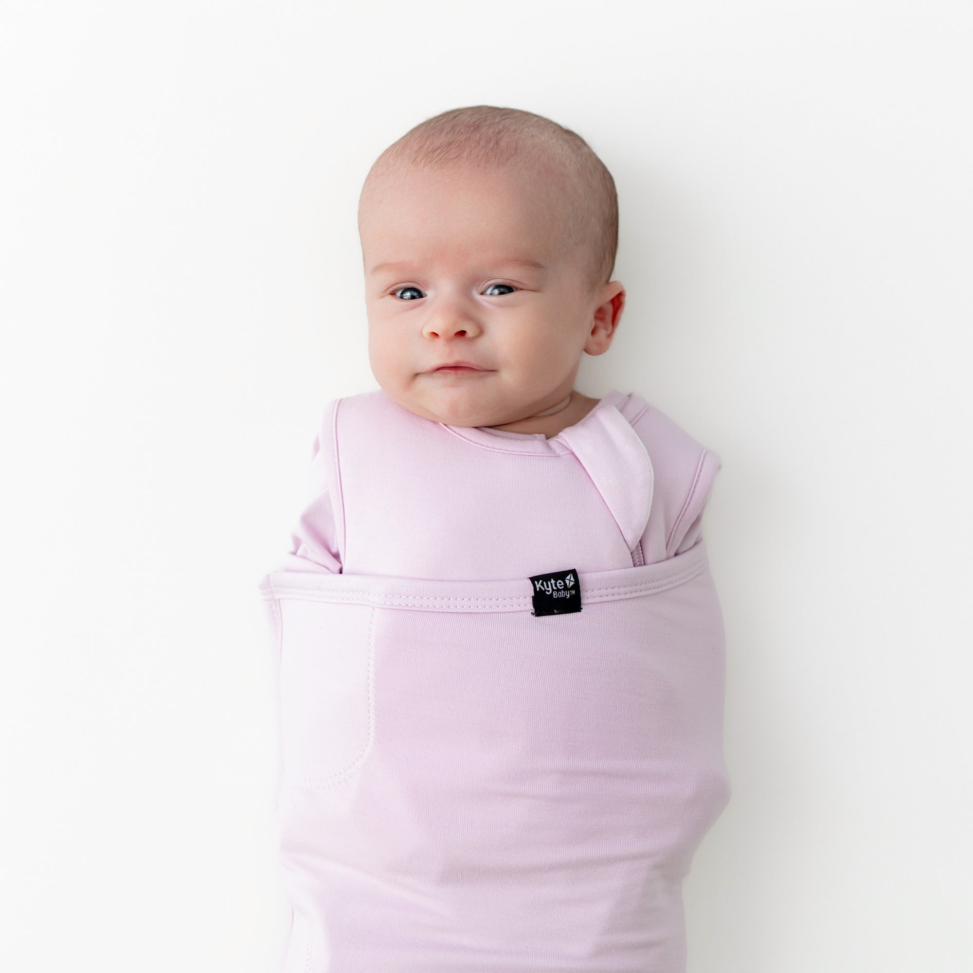 Close up of newborn swaddled in the Sleep Bag Swaddler in Thistle 1.0