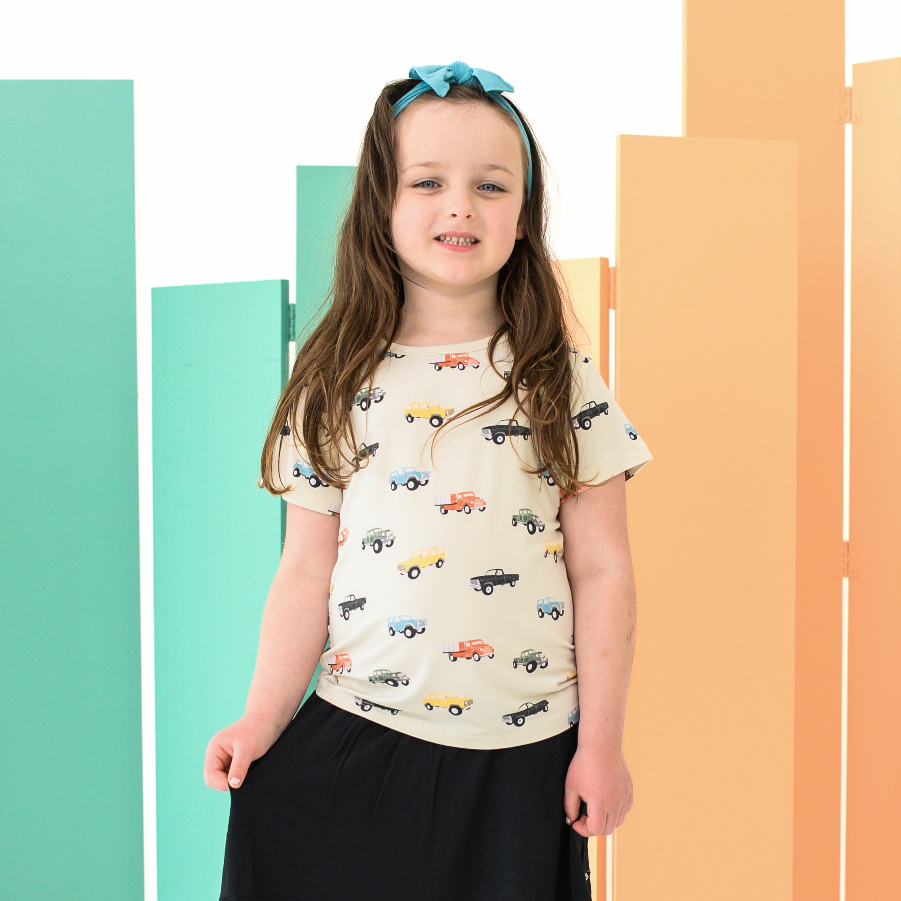 Child wearing Toddler Basic Tee in Vintage Truck with Knotted Bow