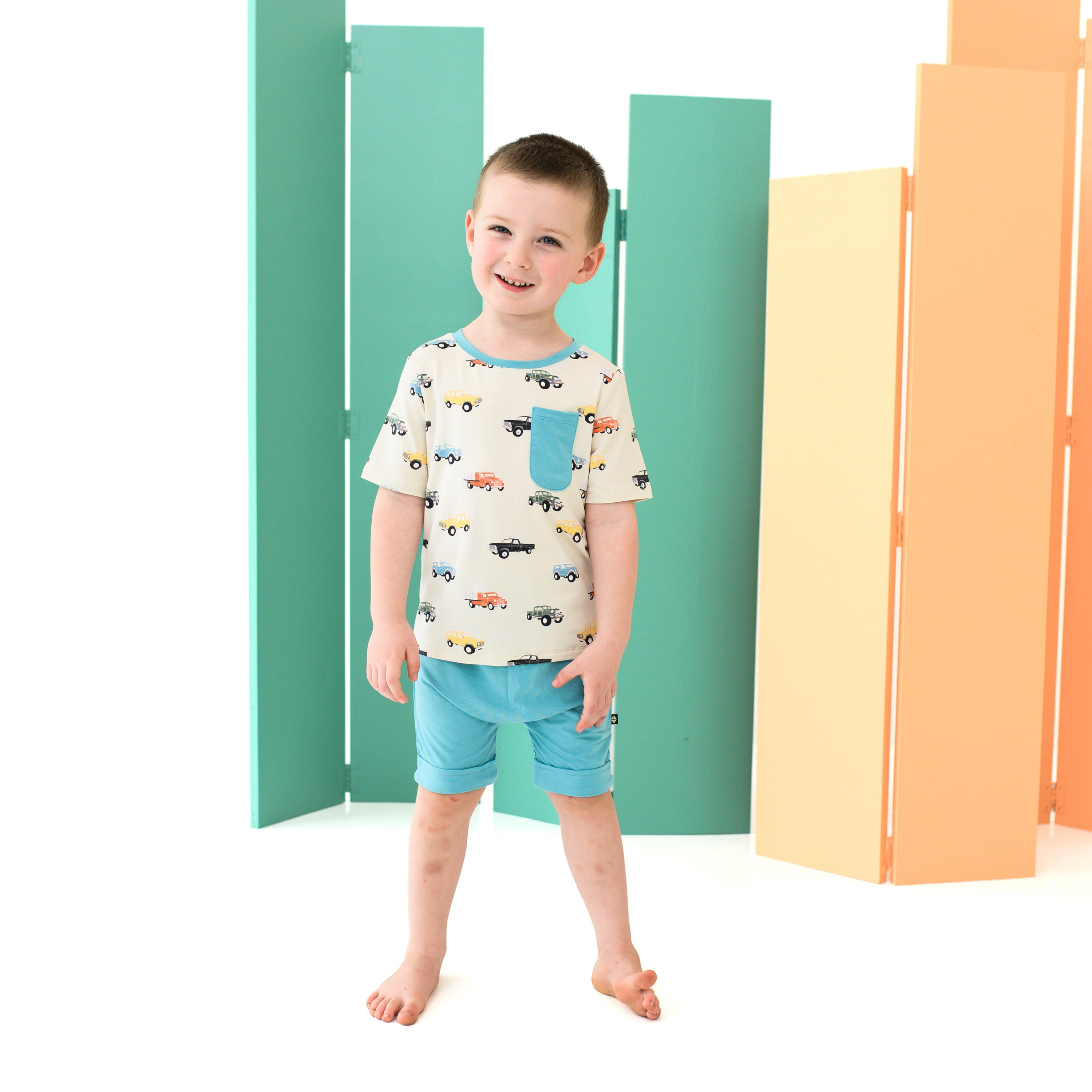 Child wearing Toddler Crew Neck Tee in Vintage Truck with Blue Shorts