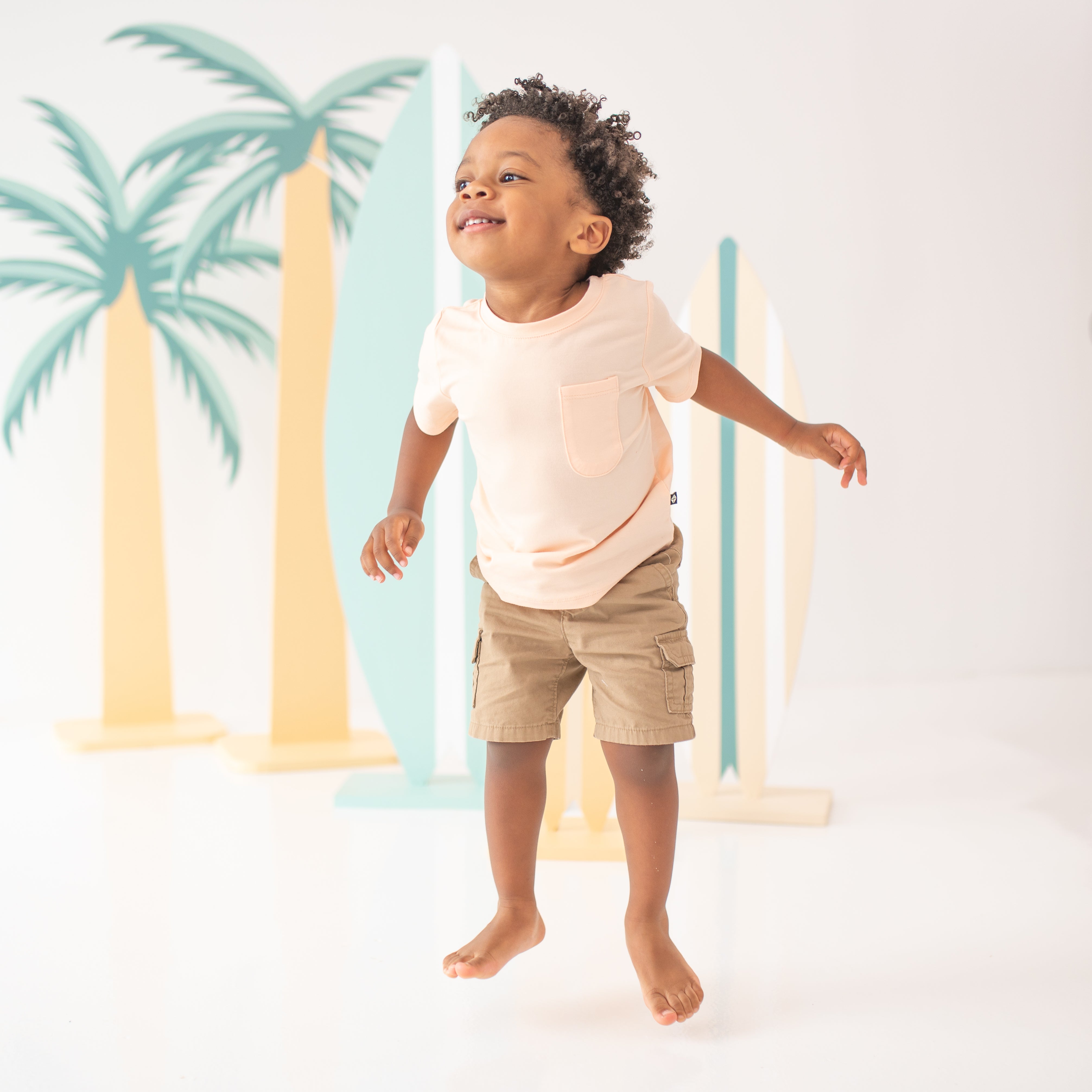 Toddler jumping while wearing the Toddler Crew Neck Tee in Canyon