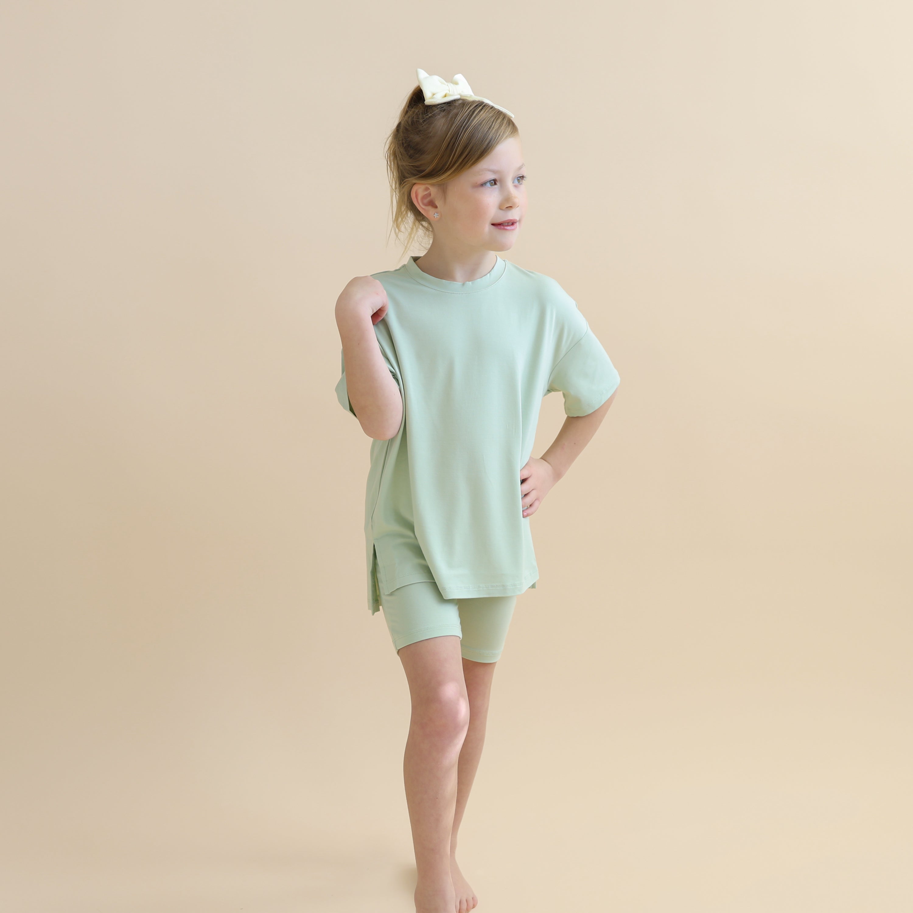 Young girl posing wearing the Toddler Biker Short Set in Basil