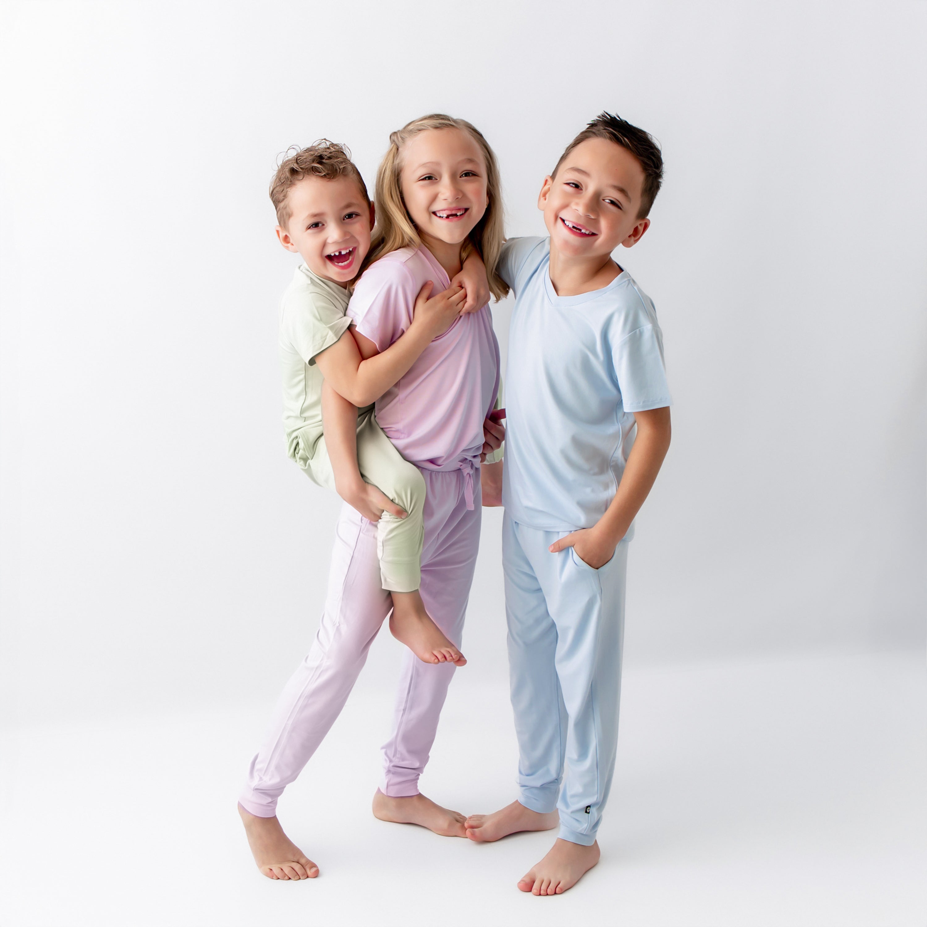 Three young models wearing the Toddler Jogger Pant in Breeze, Thistle and Basil