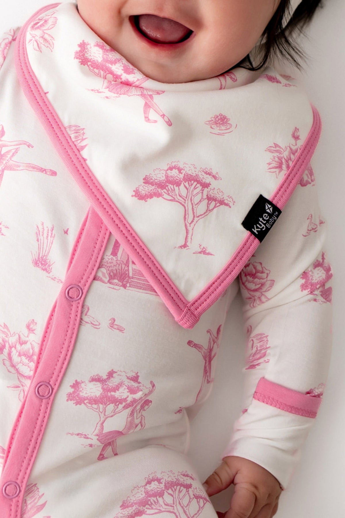 Close up of the Bib in Toile Ballet showing the kyte baby logo black tag