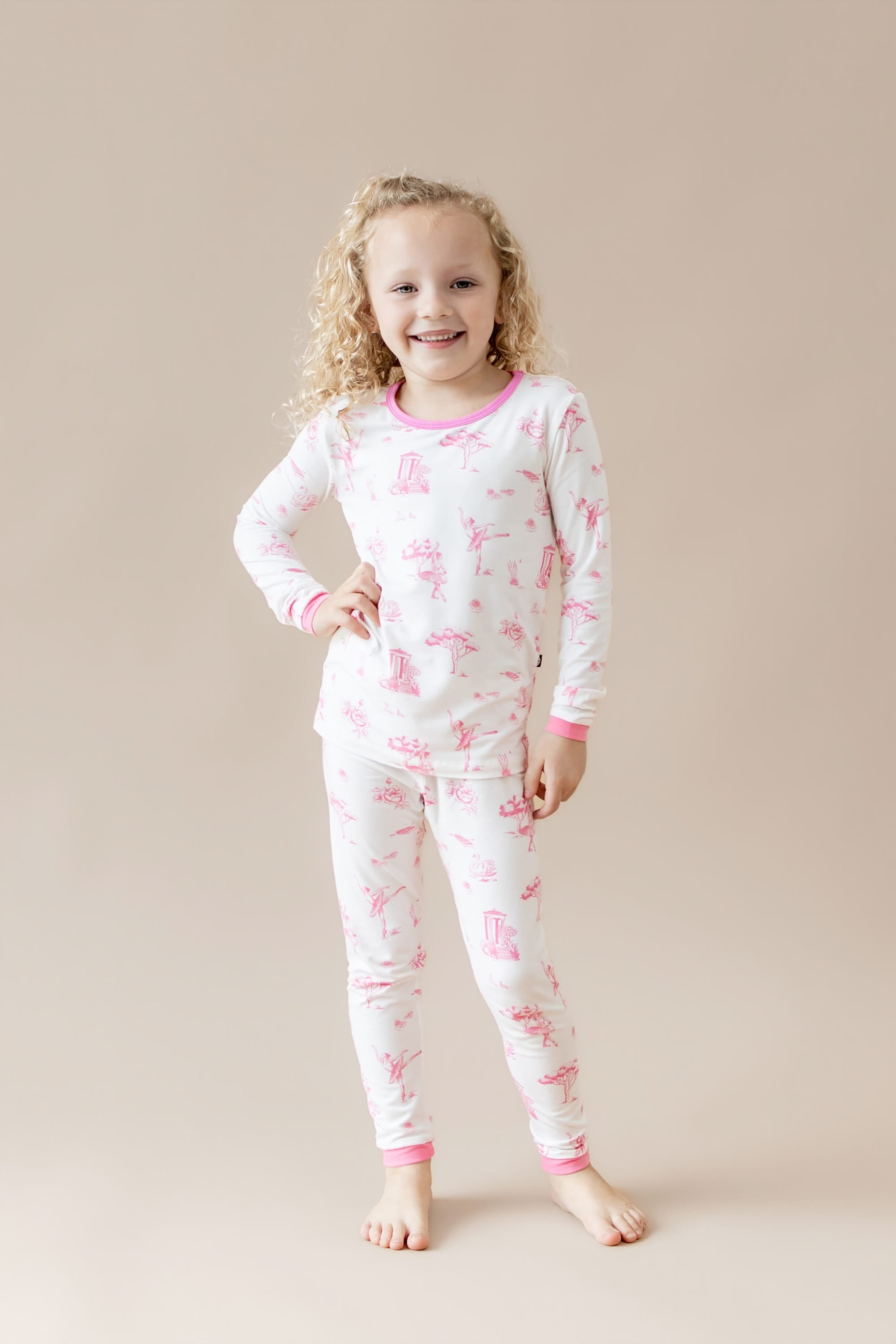 Young girl posing wearing the Long Sleeve Pajamas in Toile Ballet
