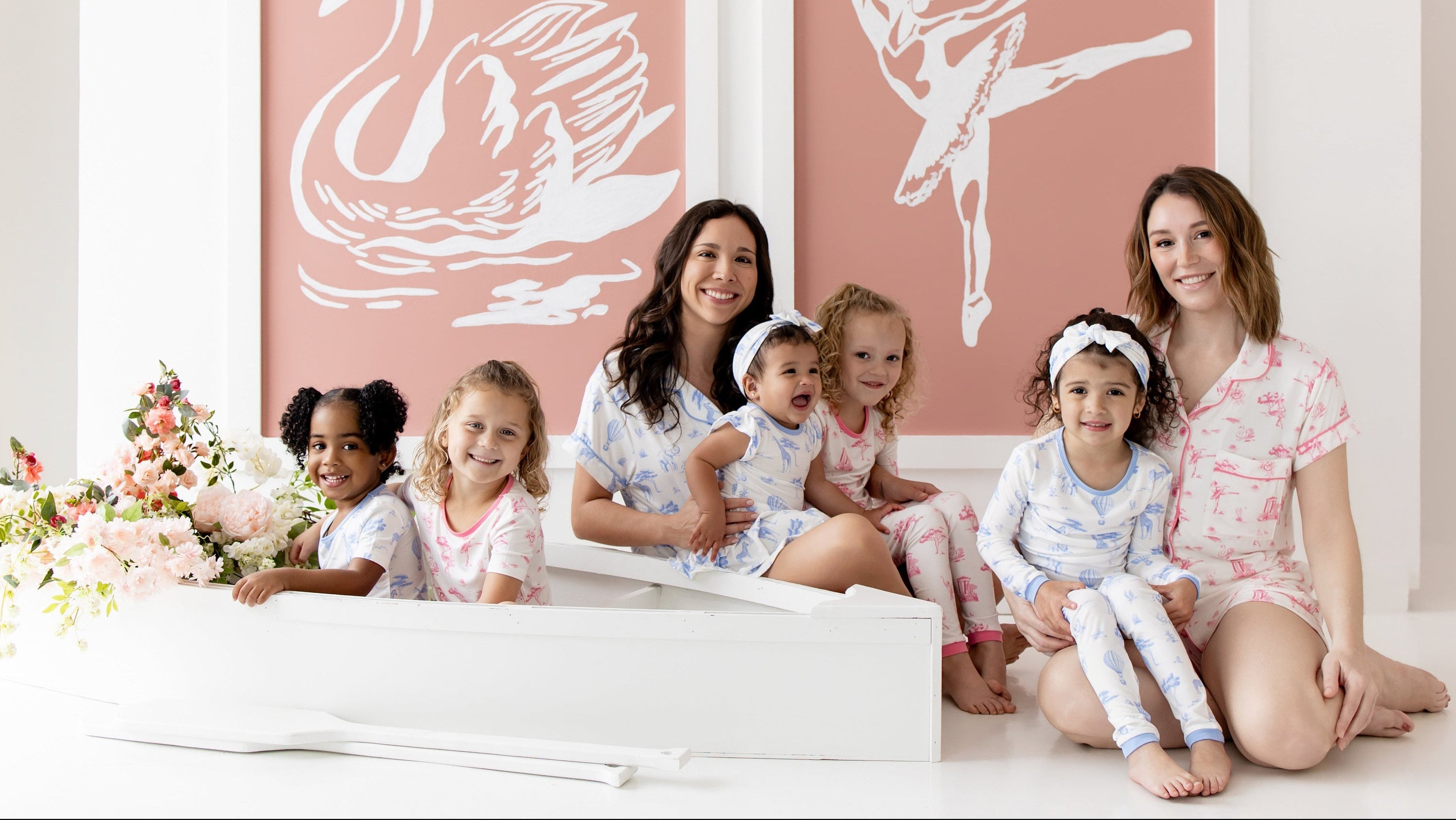 2 moms and a group of children in blue and pink toile pajamas