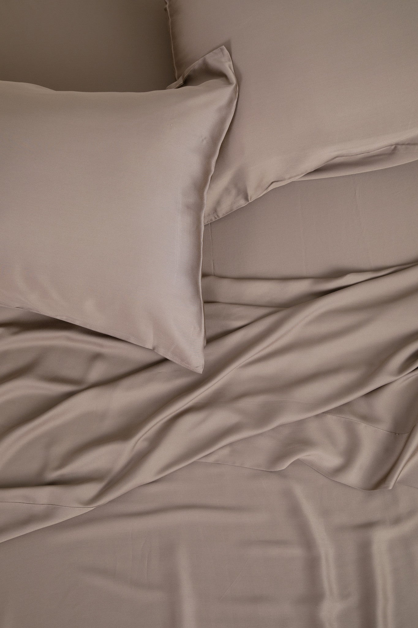 Close up of the Bamboo Sateen Sheet Set in Truffle shown on a bed