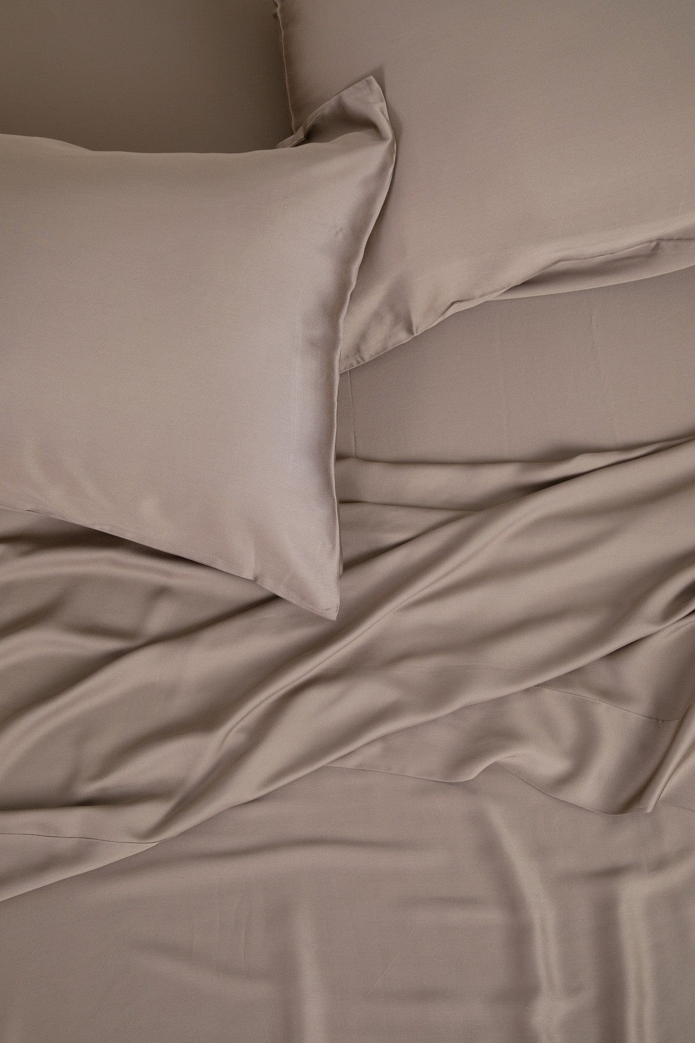 Close up of the Bamboo Sateen Sheet Set in Truffle shown on a bed