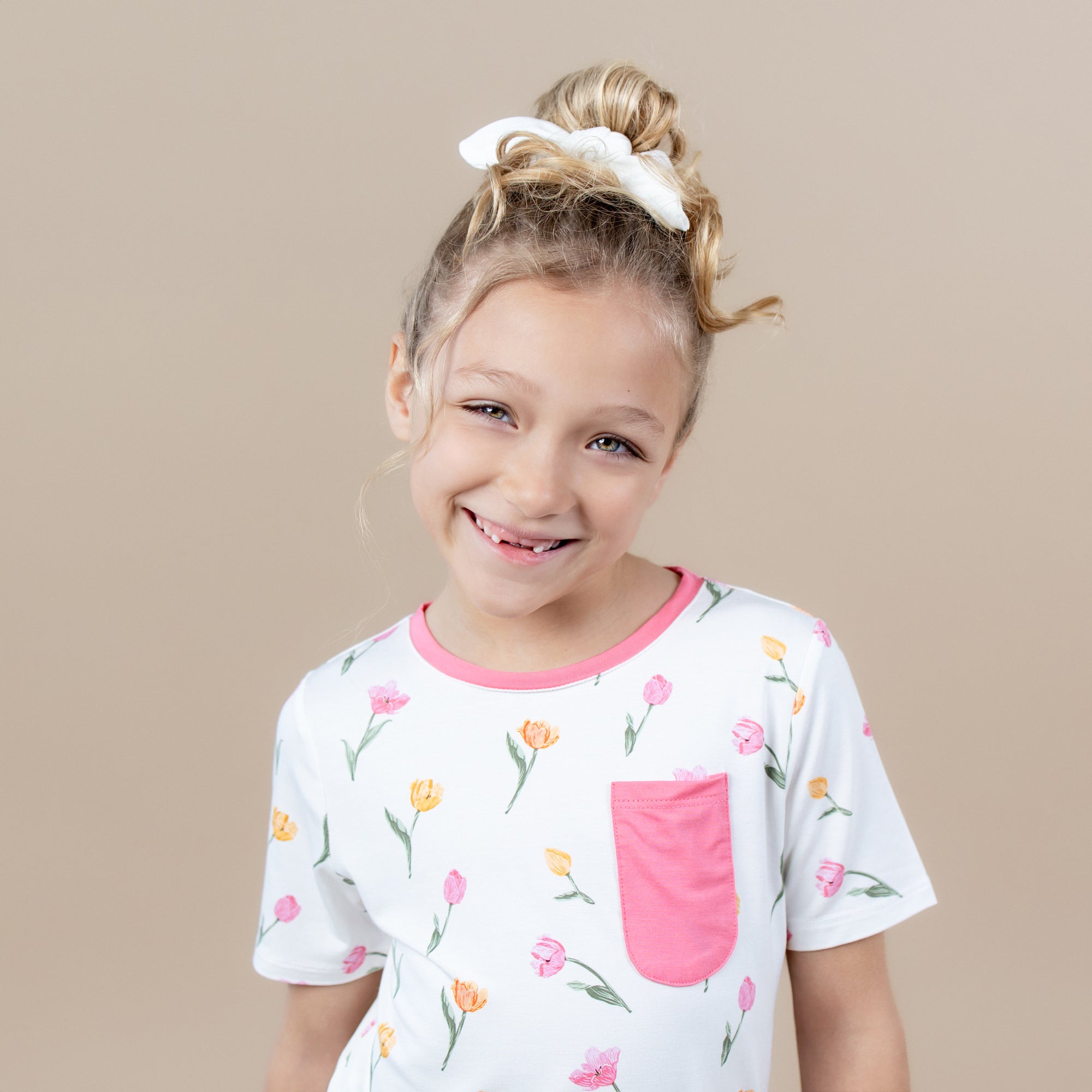 Close up of the Toddler Crew Neck Tee in Tulip shown on a young female model