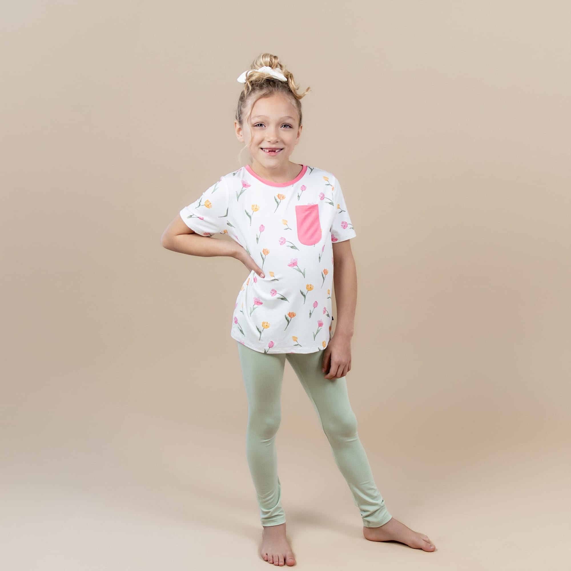 Female posing wearing the Toddler Crew Neck Tee in Tulip with light green leggings