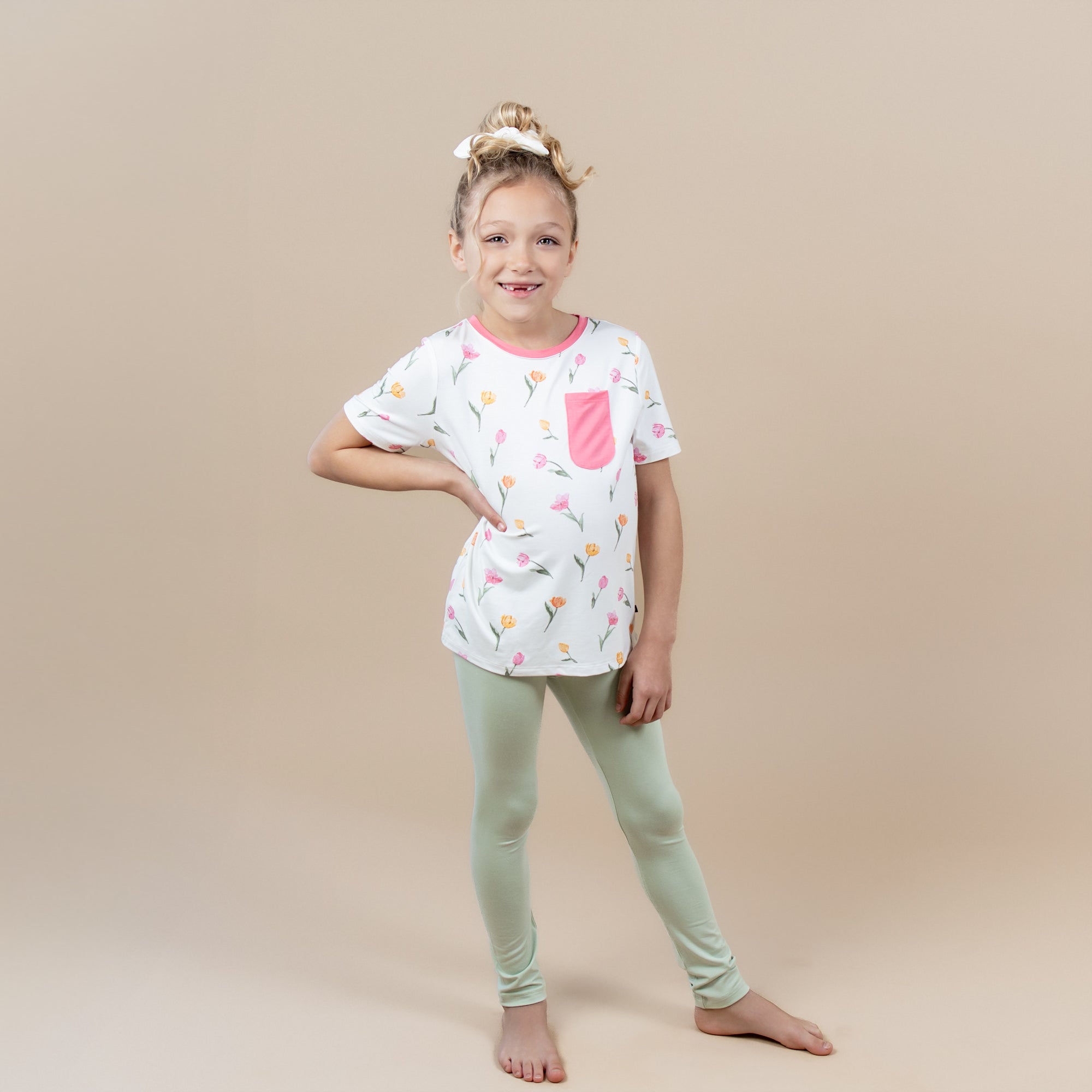 Female posing wearing the Toddler Crew Neck Tee in Tulip with light green leggings