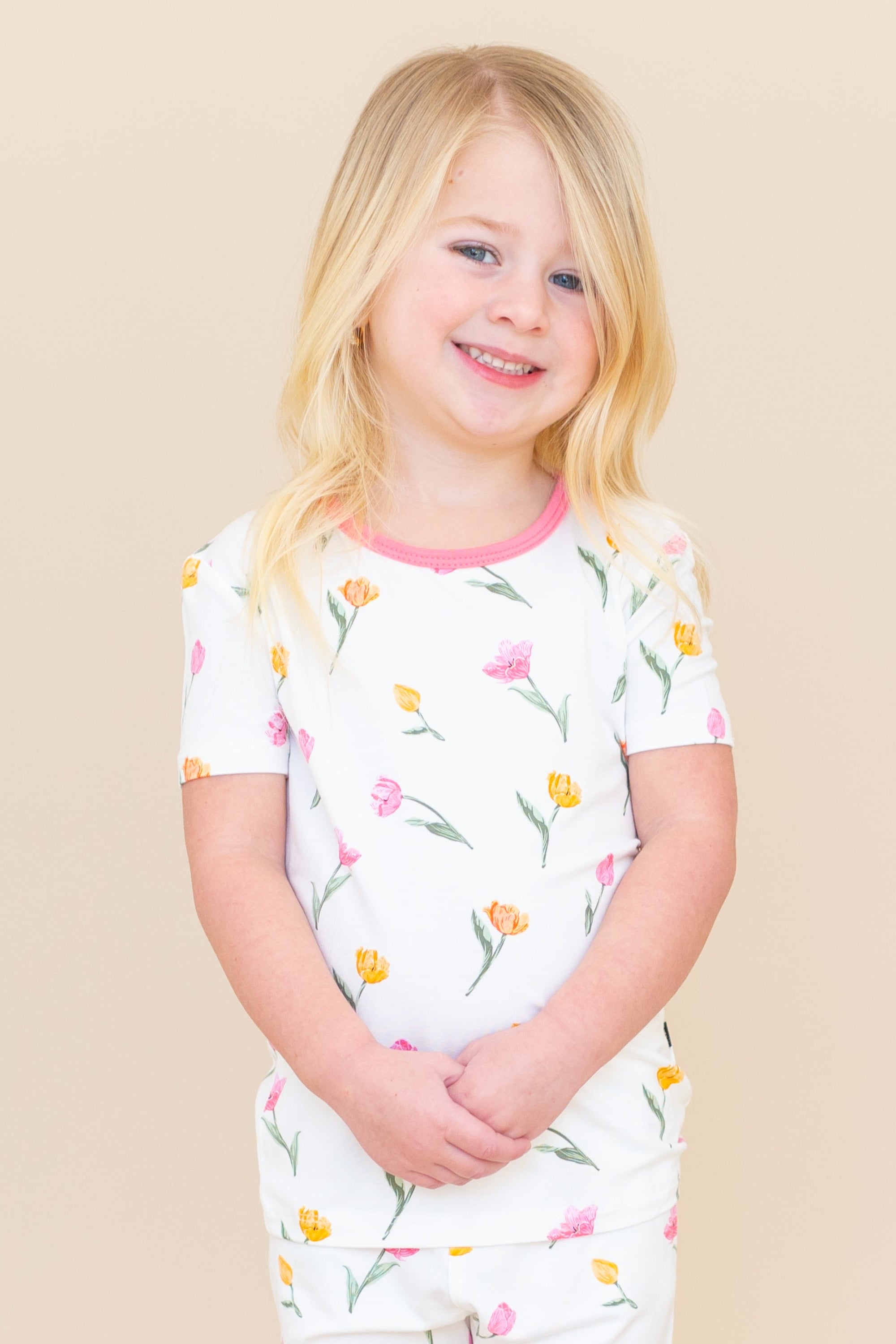 Close up of young model wearing the Short Sleeve Pajamas in Tulip