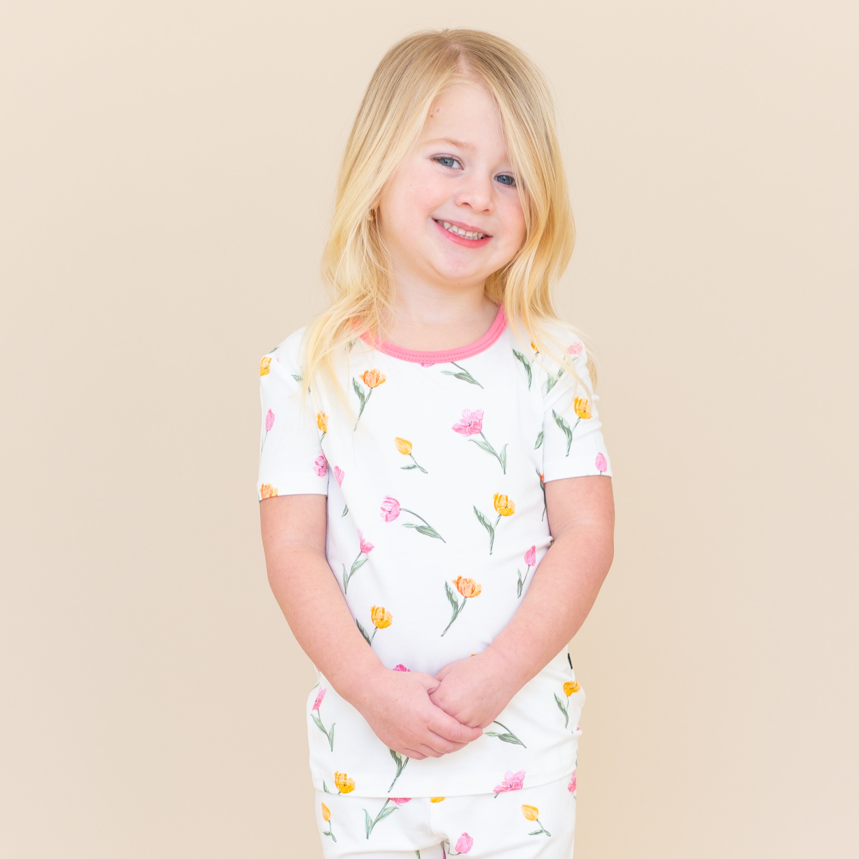 Close up of young model wearing the Short Sleeve Pajamas in Tulip