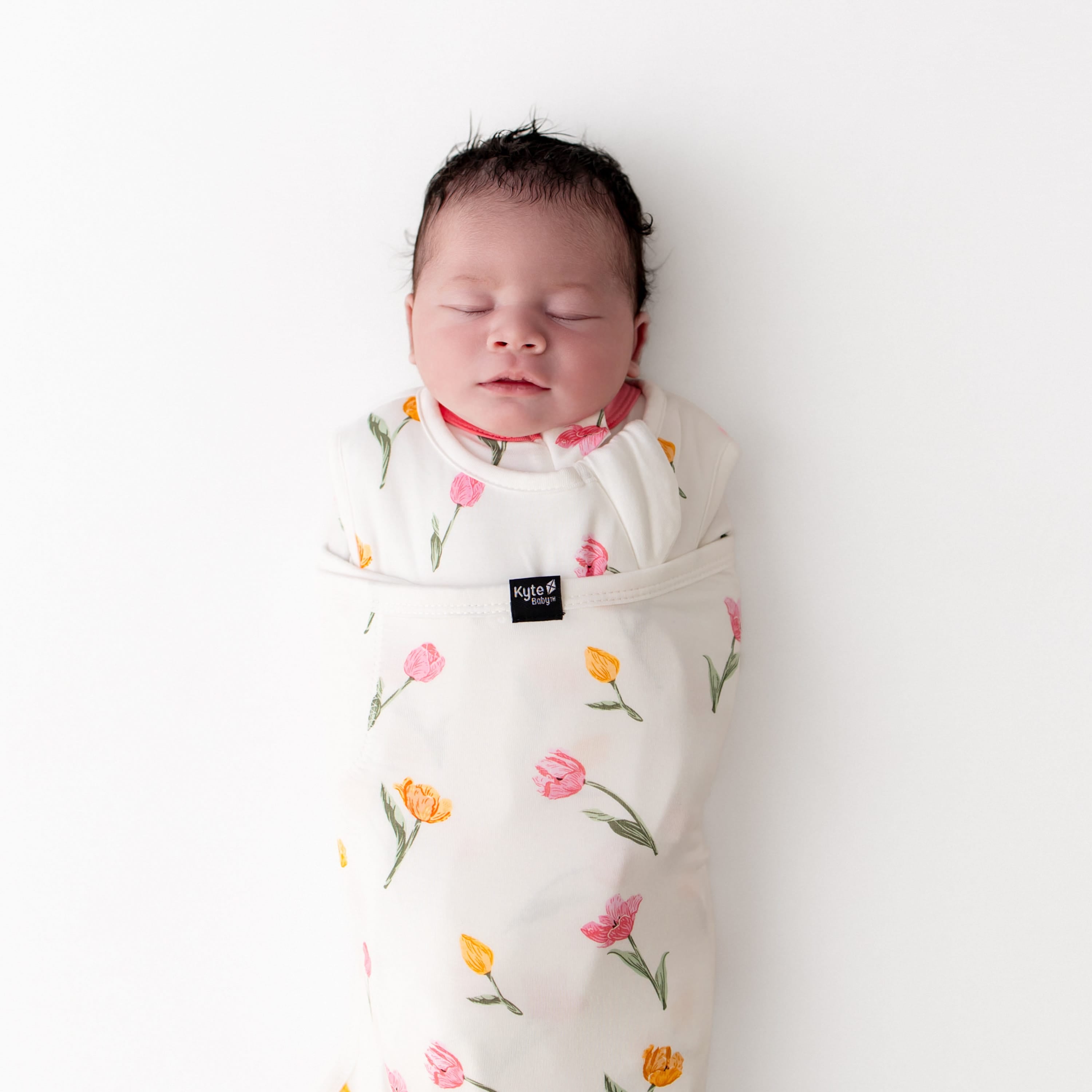 Close up of sleeping newborn swaddled in the Sleep Bag Swaddler in Tulip 1.0