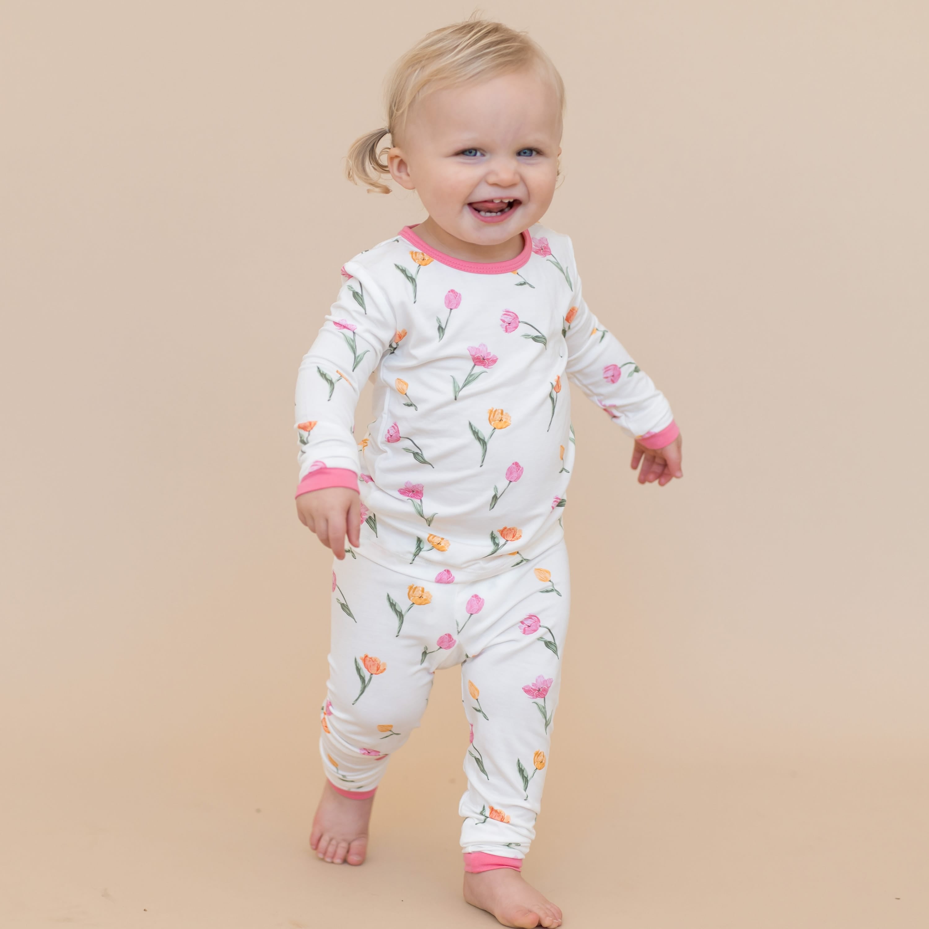 Young toddler walking wearing the Long Sleeve Pajamas in Tulip