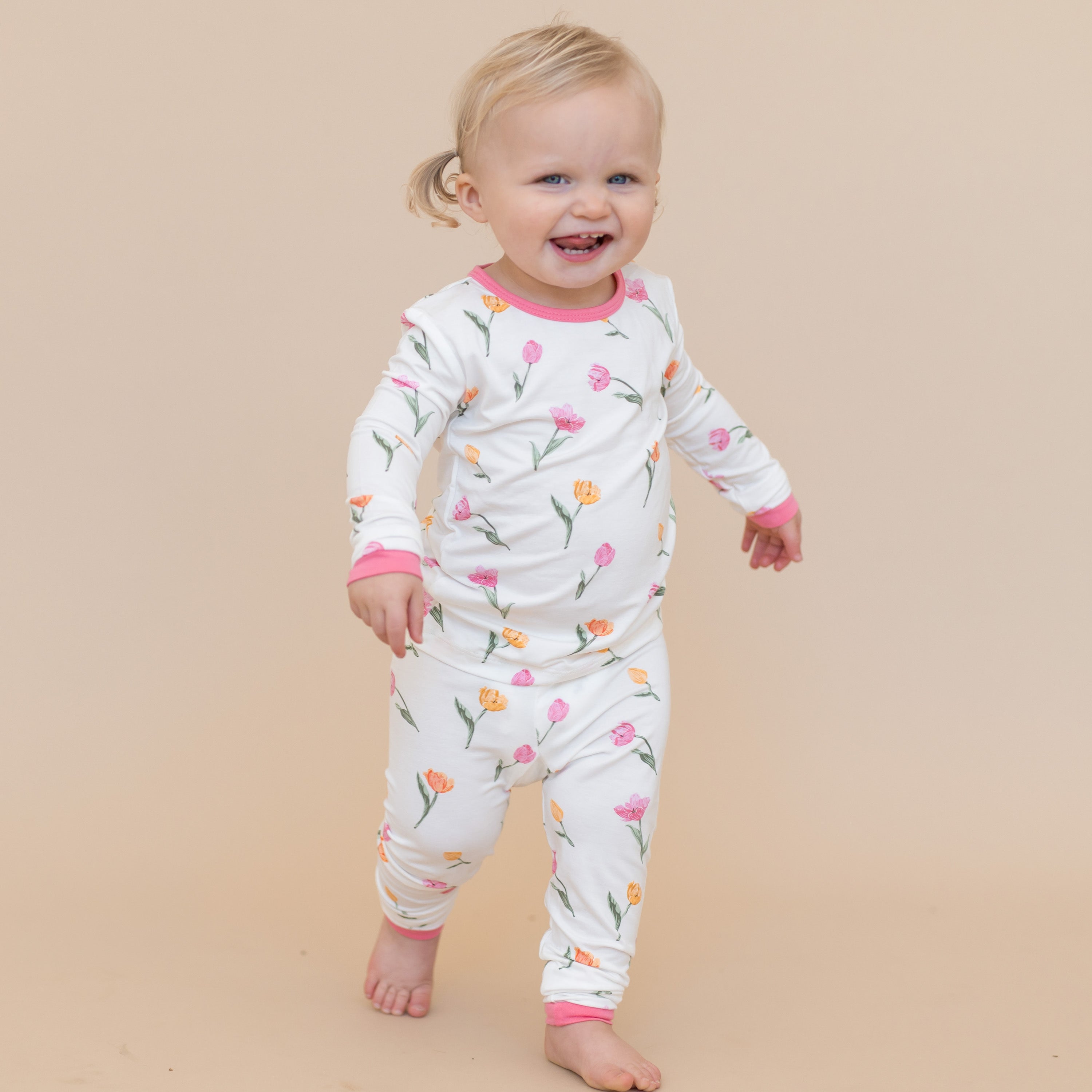 Young toddler walking wearing the Long Sleeve Pajamas in Tulip