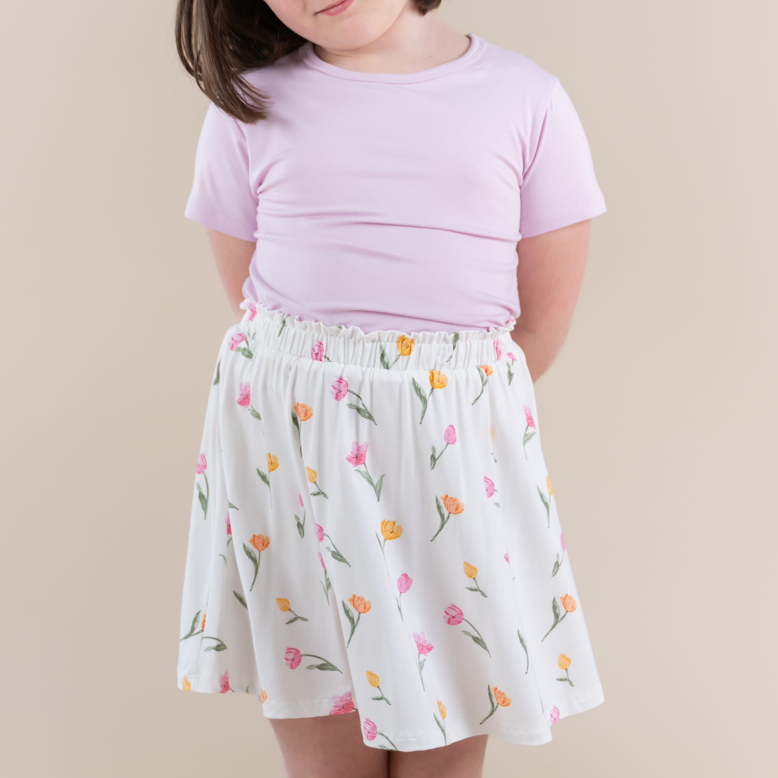 Close up of the Toddler Skort in Tulip shown with a basic tee in thistle on a young model