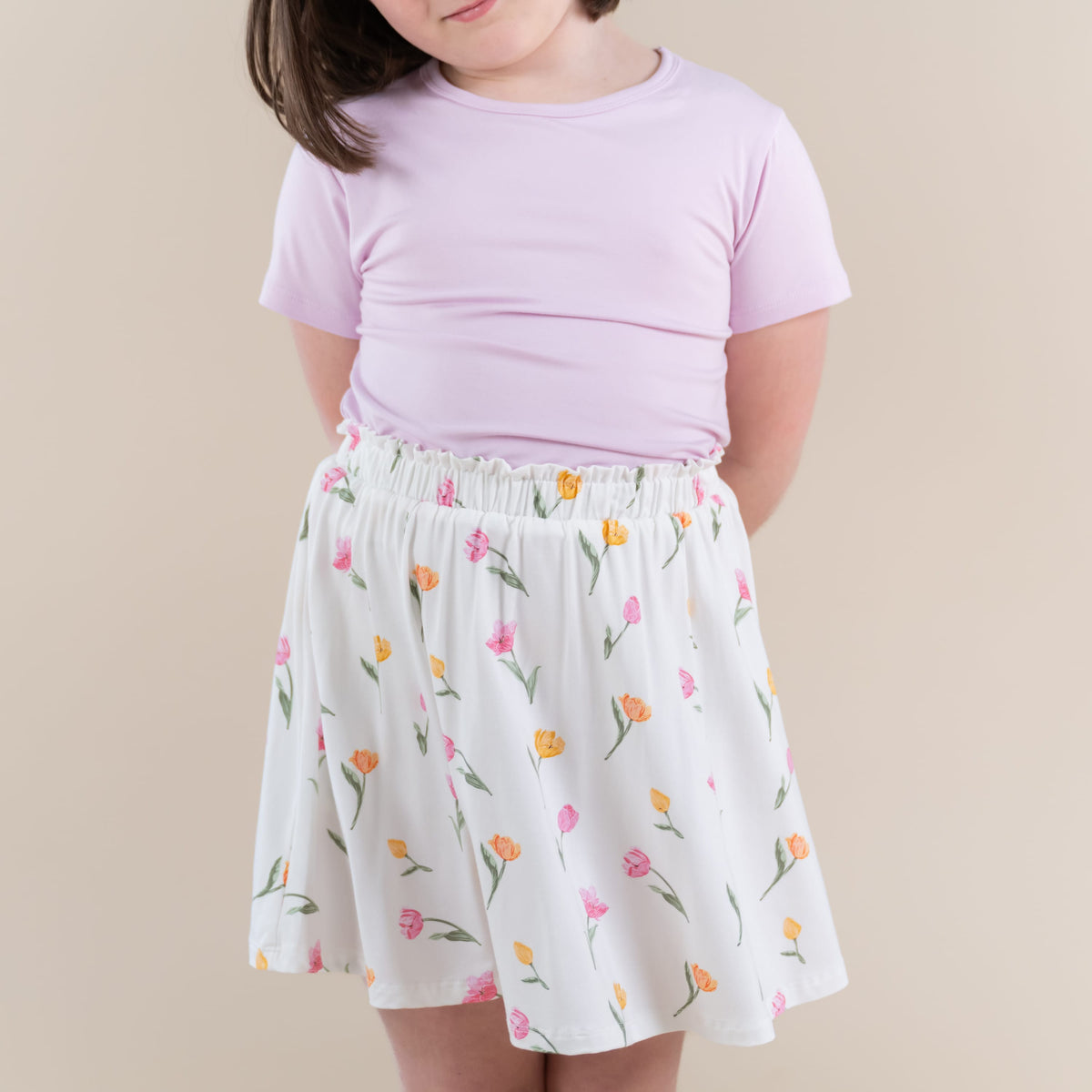 Close up of the Toddler Skort in Tulip shown with a basic tee in thistle on a young model