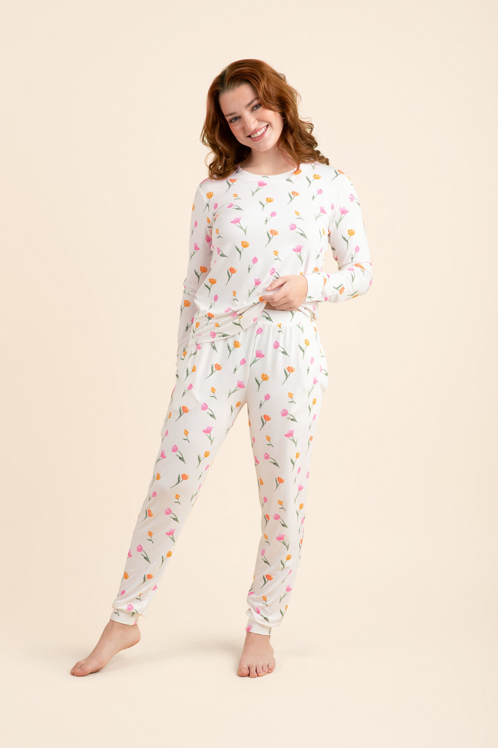 Female modeling the Women's Jogger Pajama Set in Tulip posing in front of a light neutral background