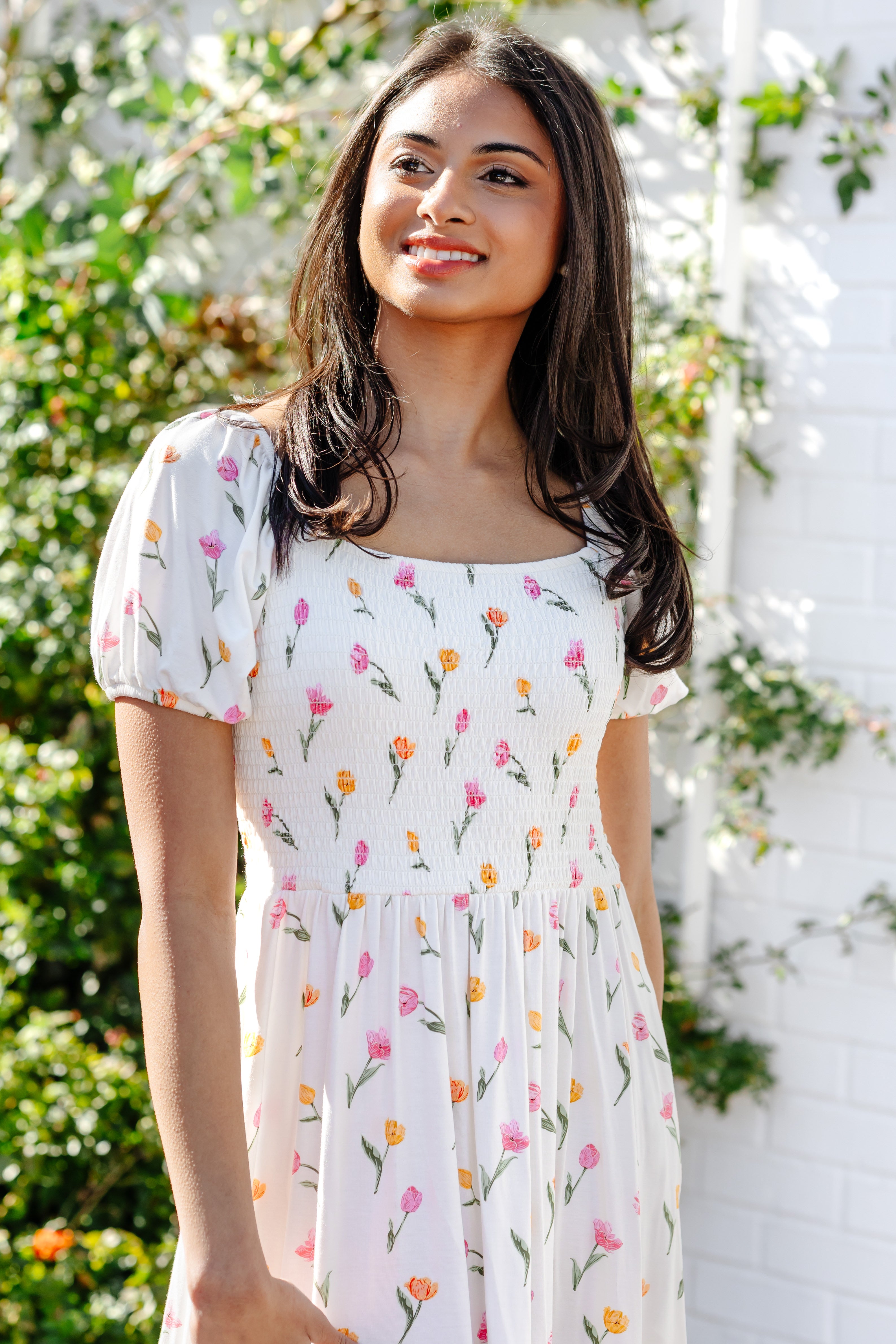 Close up of the smocked bodice on the Women’s Smocked Dress in Tulip shown on a female model