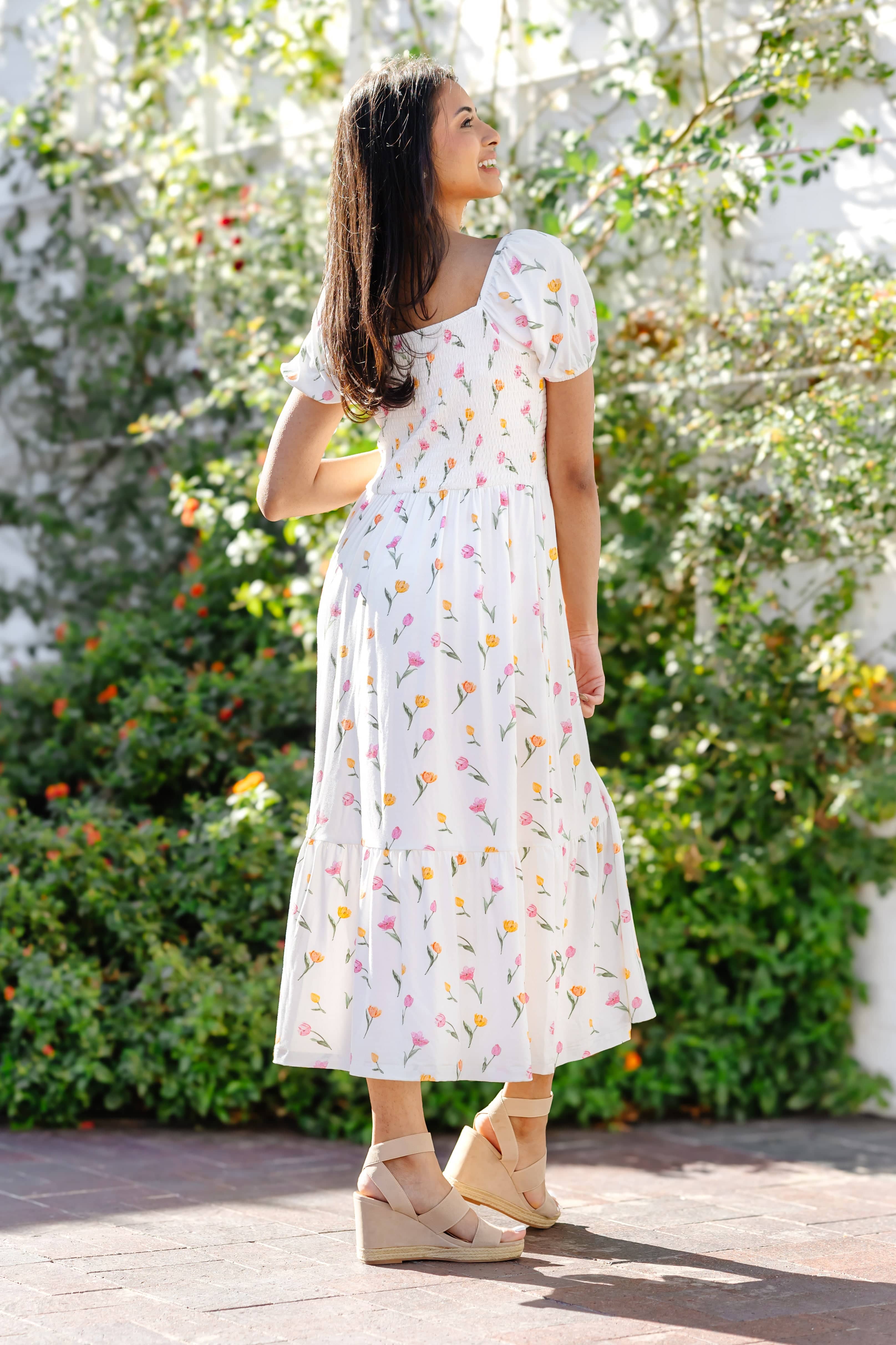 The back of the Women’s Smocked Dress in Tulip showing the square backline on a model