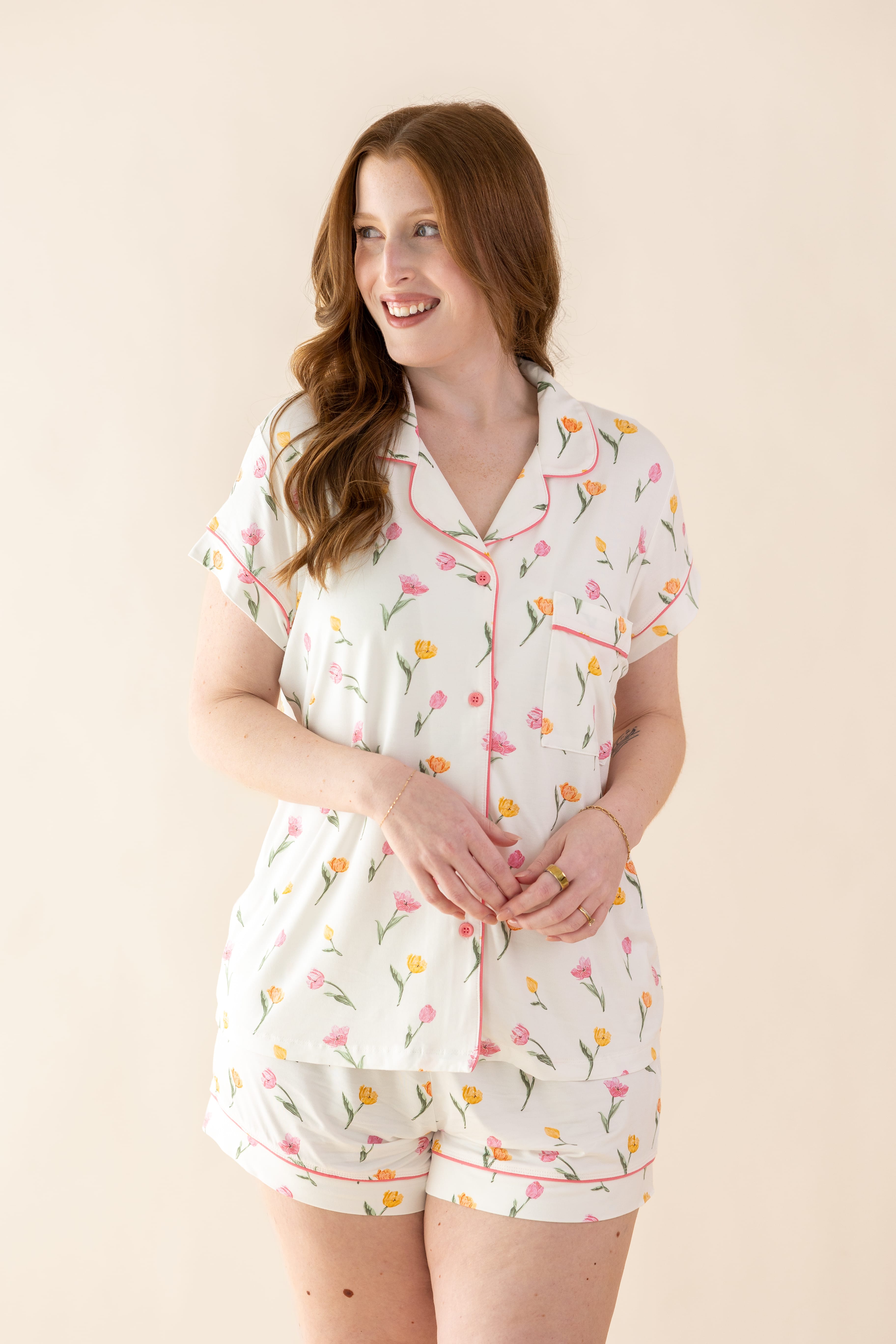 Female modeling the Women's Short Sleeve Pajama Set in Tulip standing in front of a light cream background