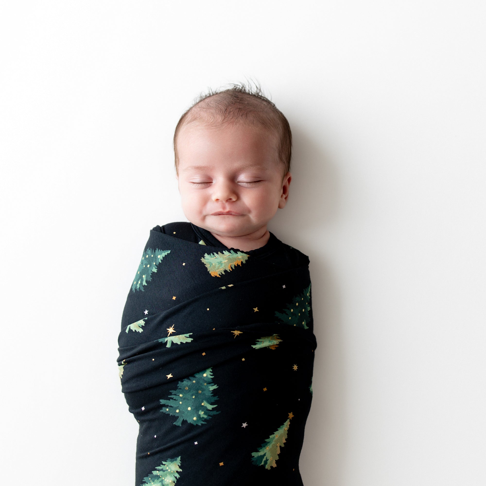 Close up of sleeping baby swaddled in the Swaddle Blanket in Twinkle Tree