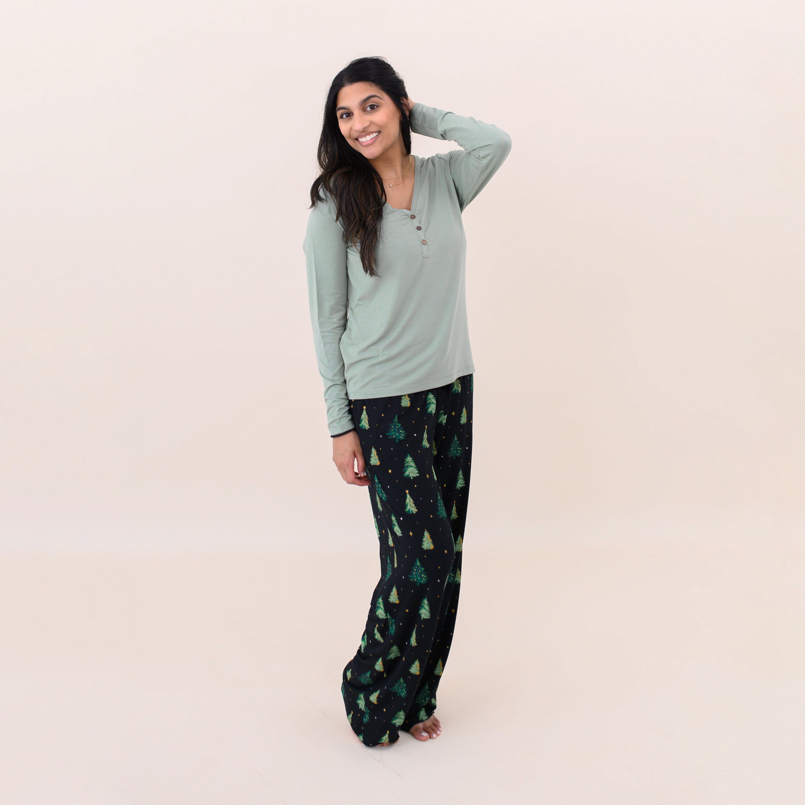 Female model wearing the Women's Lounge Pants in Twinkle Tree paired with a Thyme Women's Henley tee