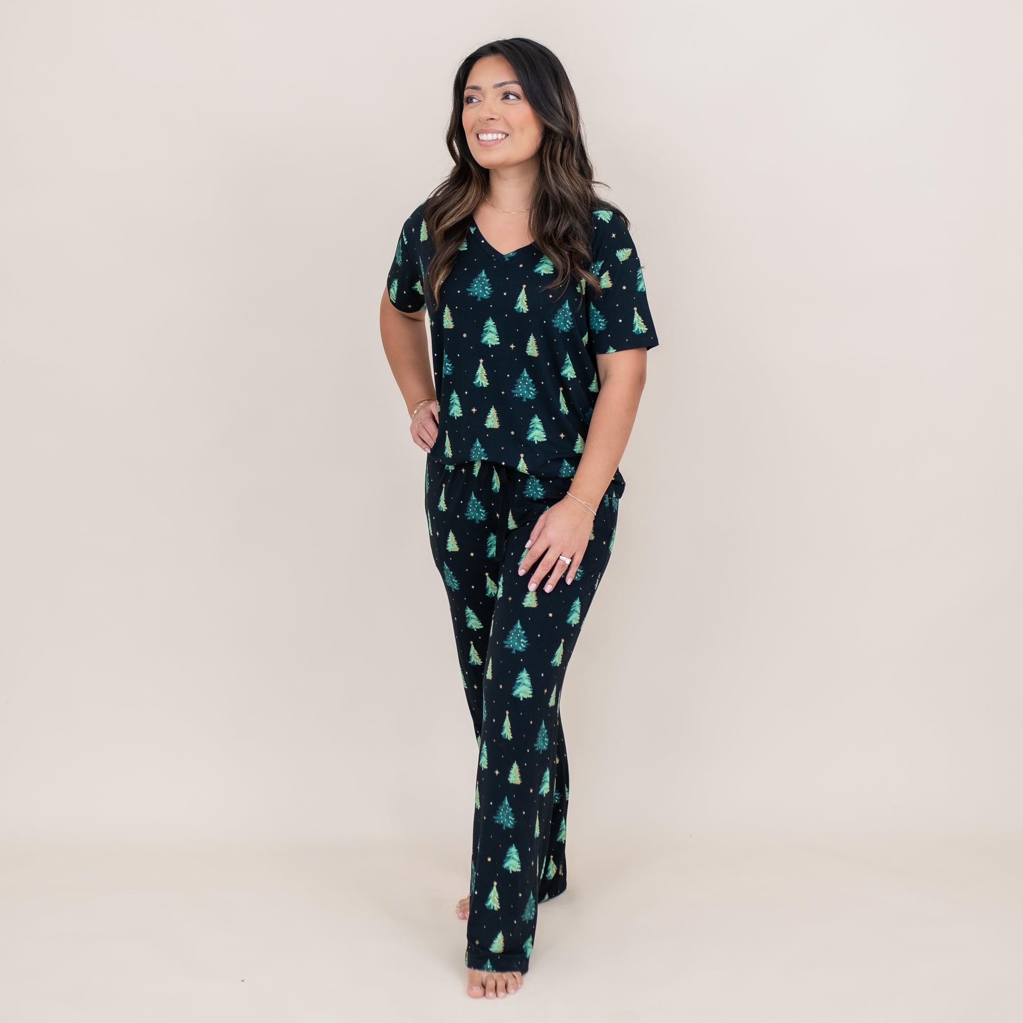 Smiling female model wearing the Women's Relaxed Fit V-Neck in Twinkle Tree and matching lounge pants