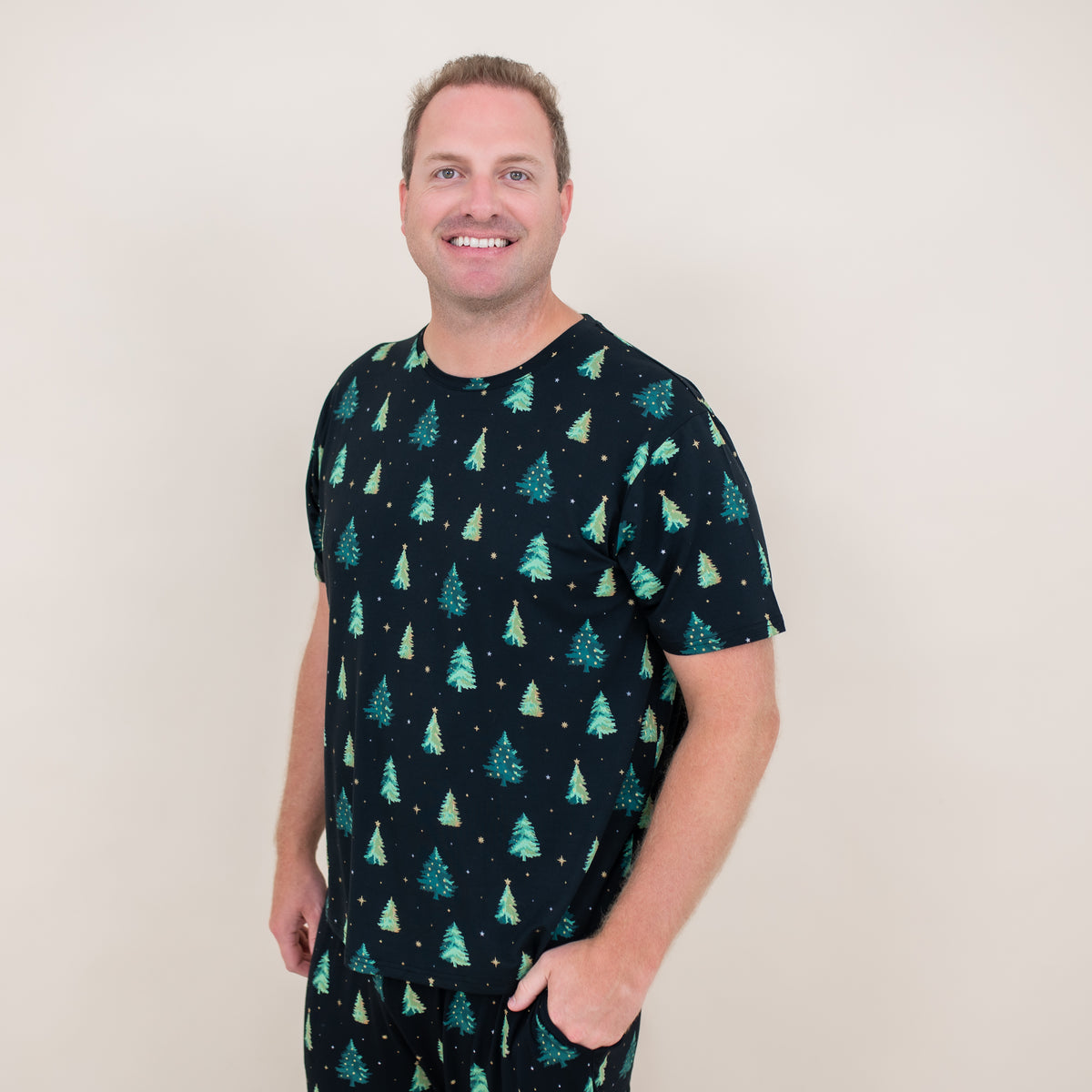 Male model wearing the Men's Crew Neck Tee in Twinkle Tree with matching lounge pants