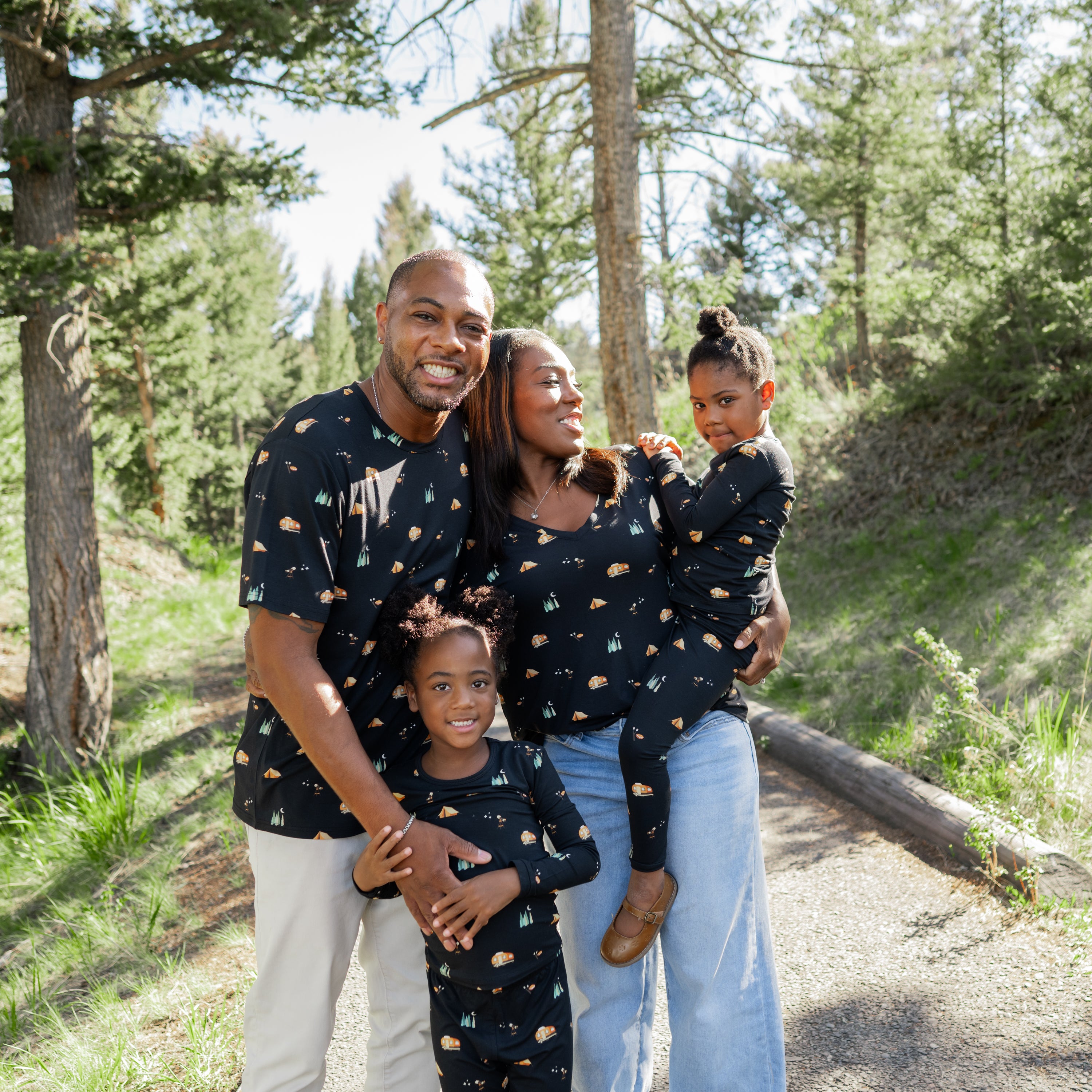 Family in Under the Stars print t-shirts and pajamas with a forest background