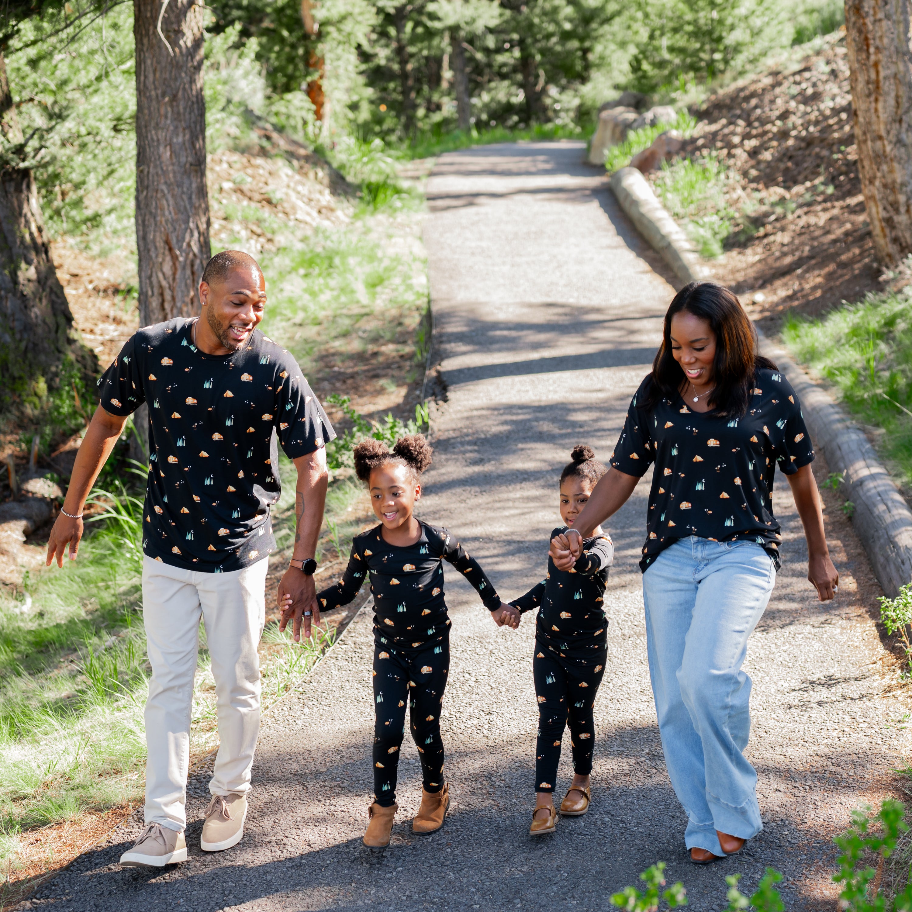 Family in Under the Stars print holding hands walking on a trail