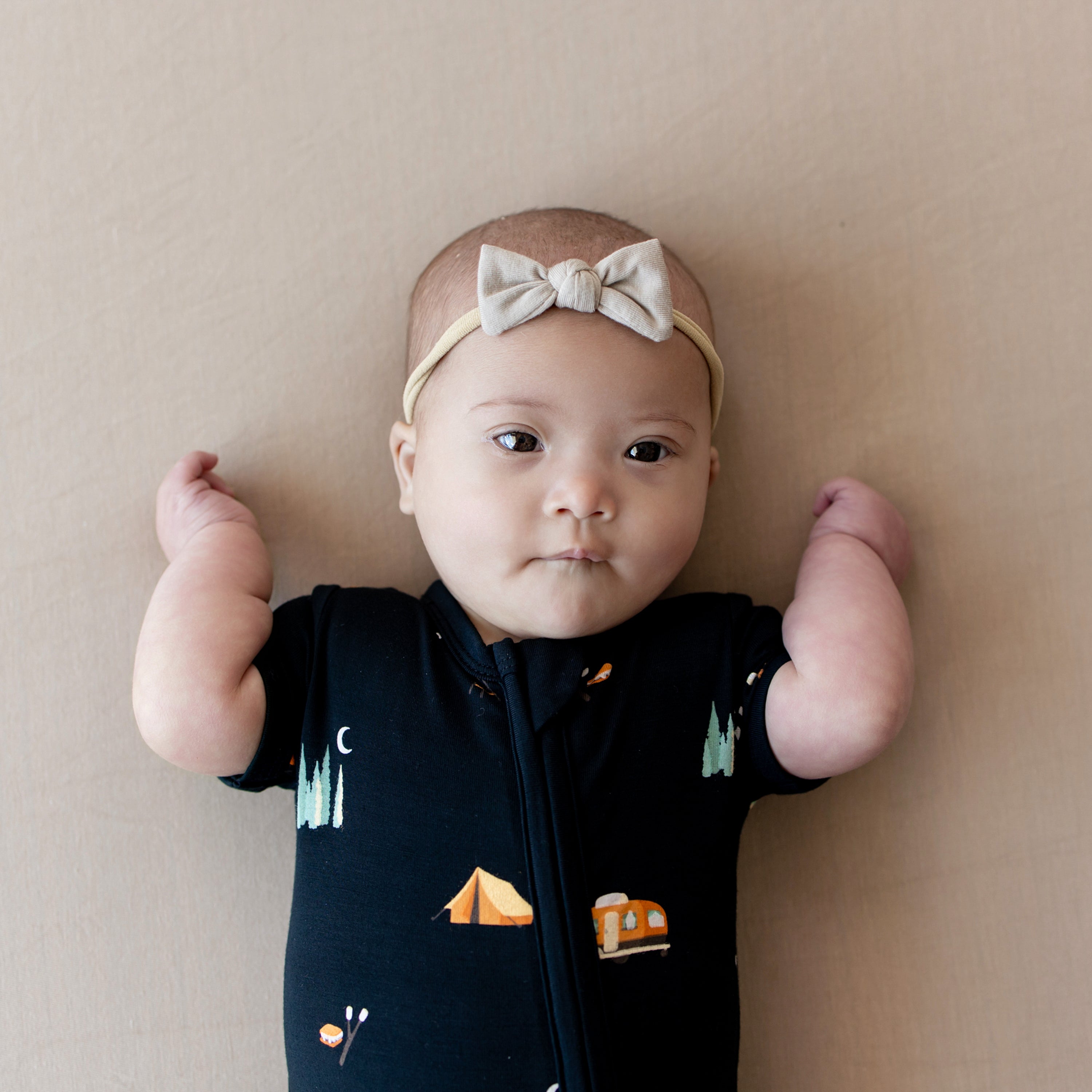 Close up of infant wearing the Zippered Shortall Romper in Under the Stars