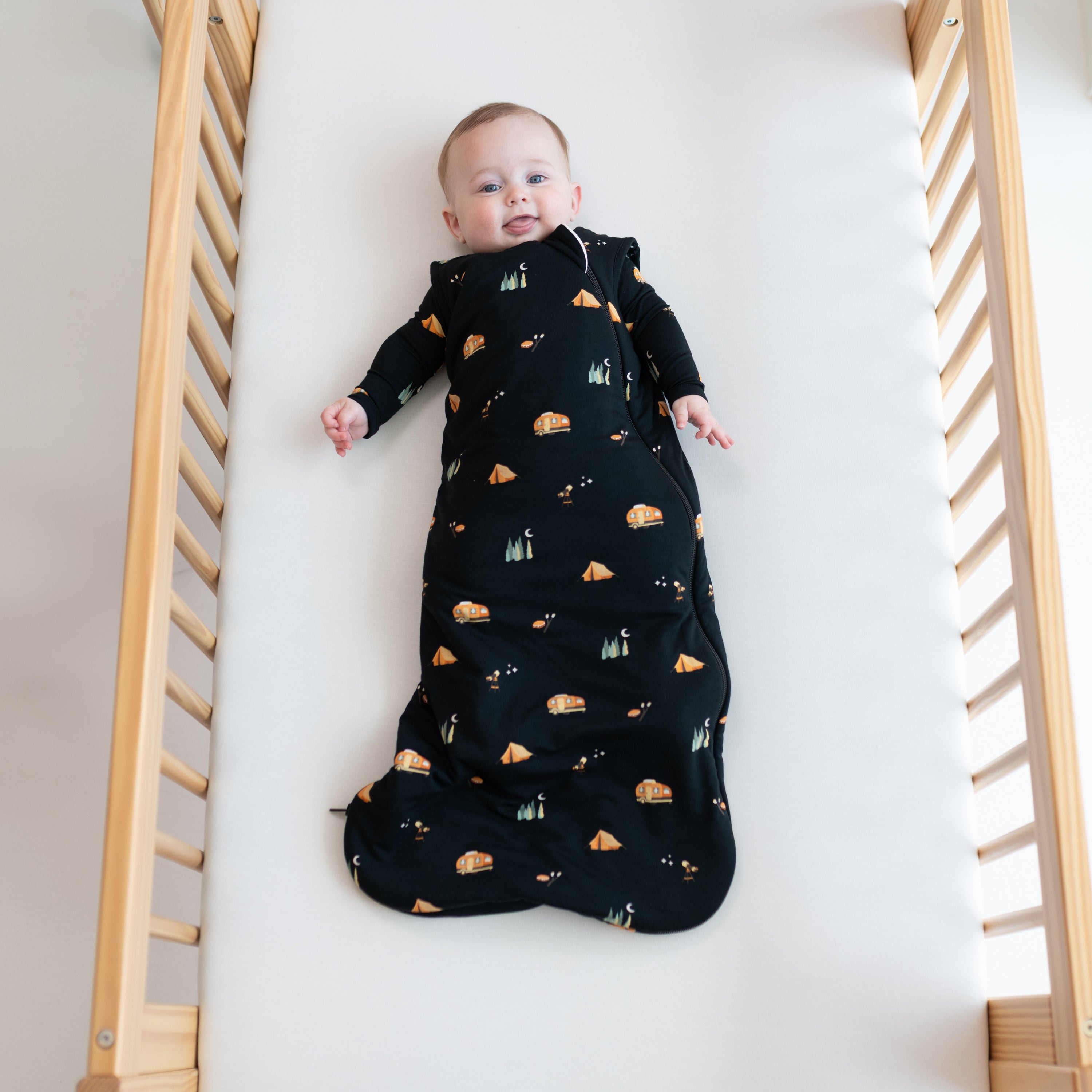Baby wearing National Parks Sleep Bag TOG 1.0 in Under the Stars over matching pajamas