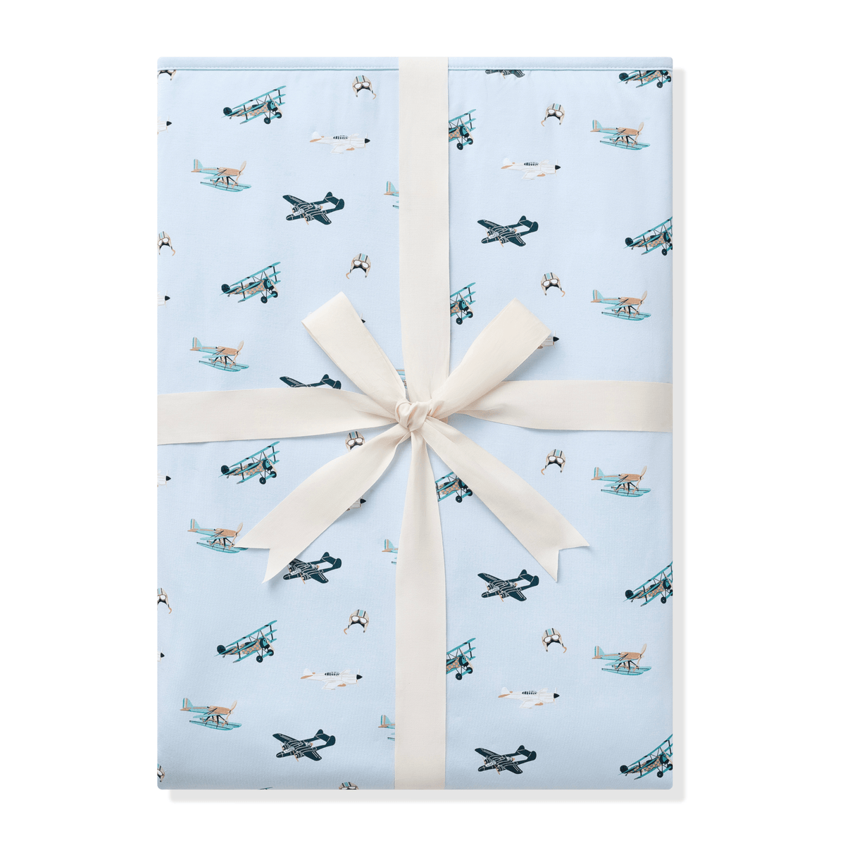 Youth Blanket in Take Off 1.0 shown wrapped in its packaging tied with a linen bow