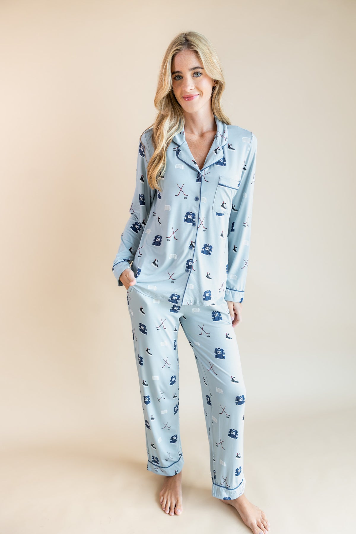 Modal wearing Blue Long-Sleeved Women's Pajama Set with Vintage Hockey print on a beige background