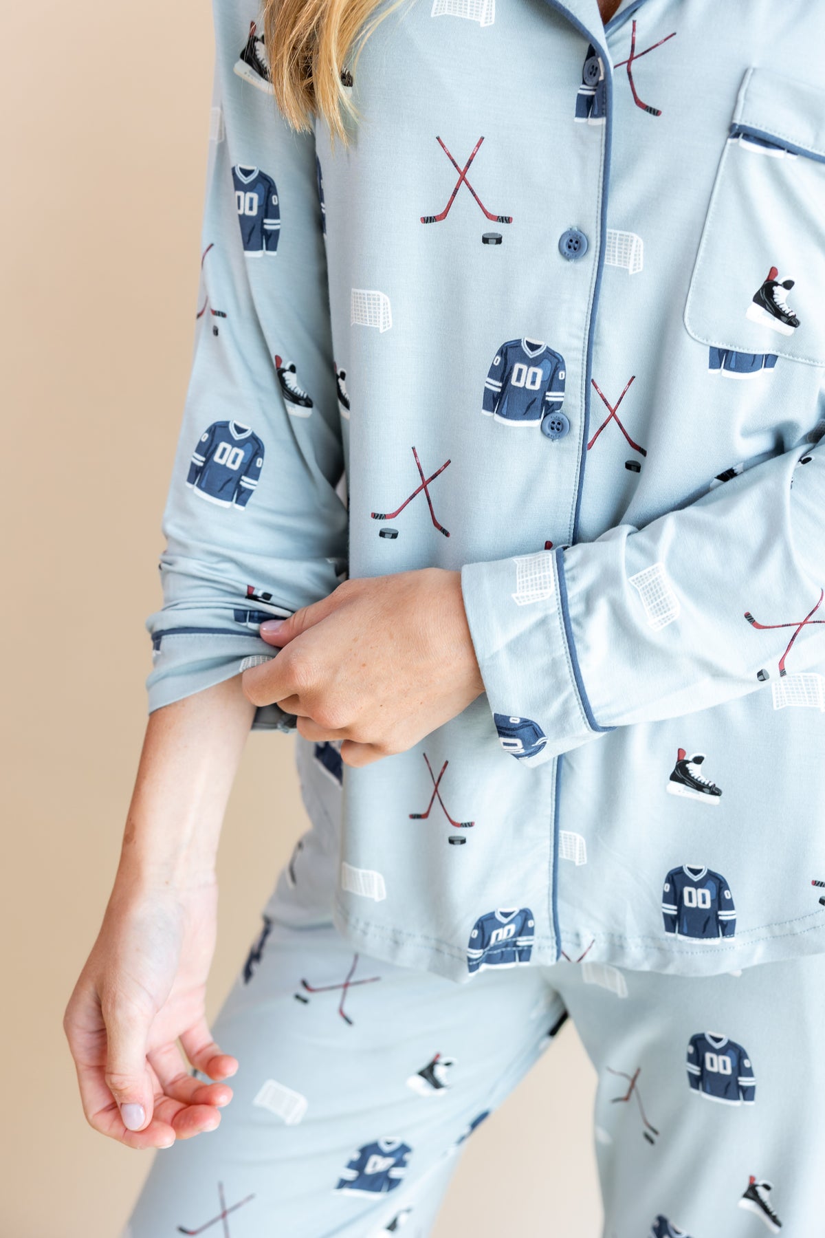 Close up of Blue Long-Sleeved Women's Pajama Set with Vintage Hockey print on a beige background