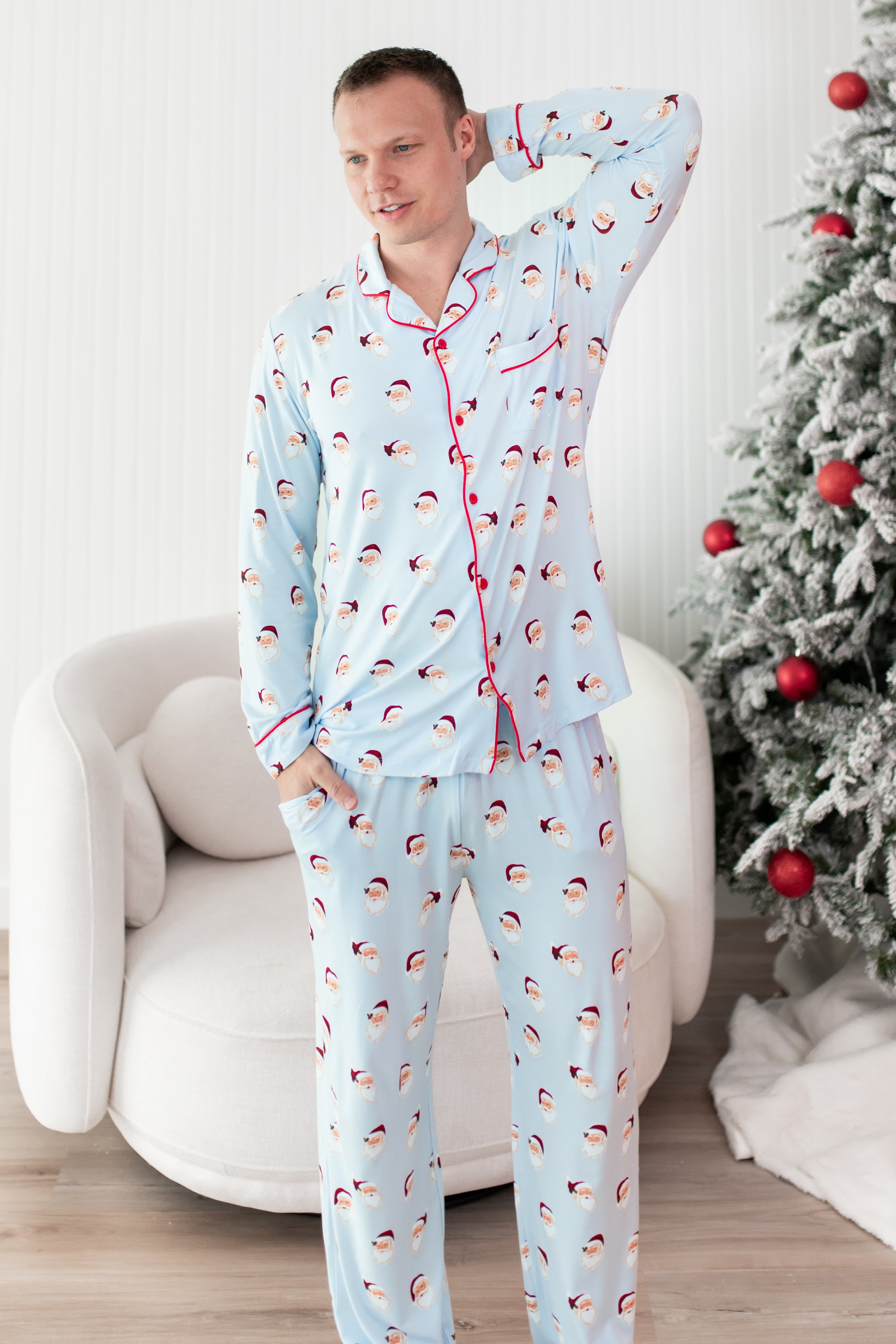 Male model wearing the Men's Long Sleeve Pajama Set in Vintage Santa with one arm up behind his head