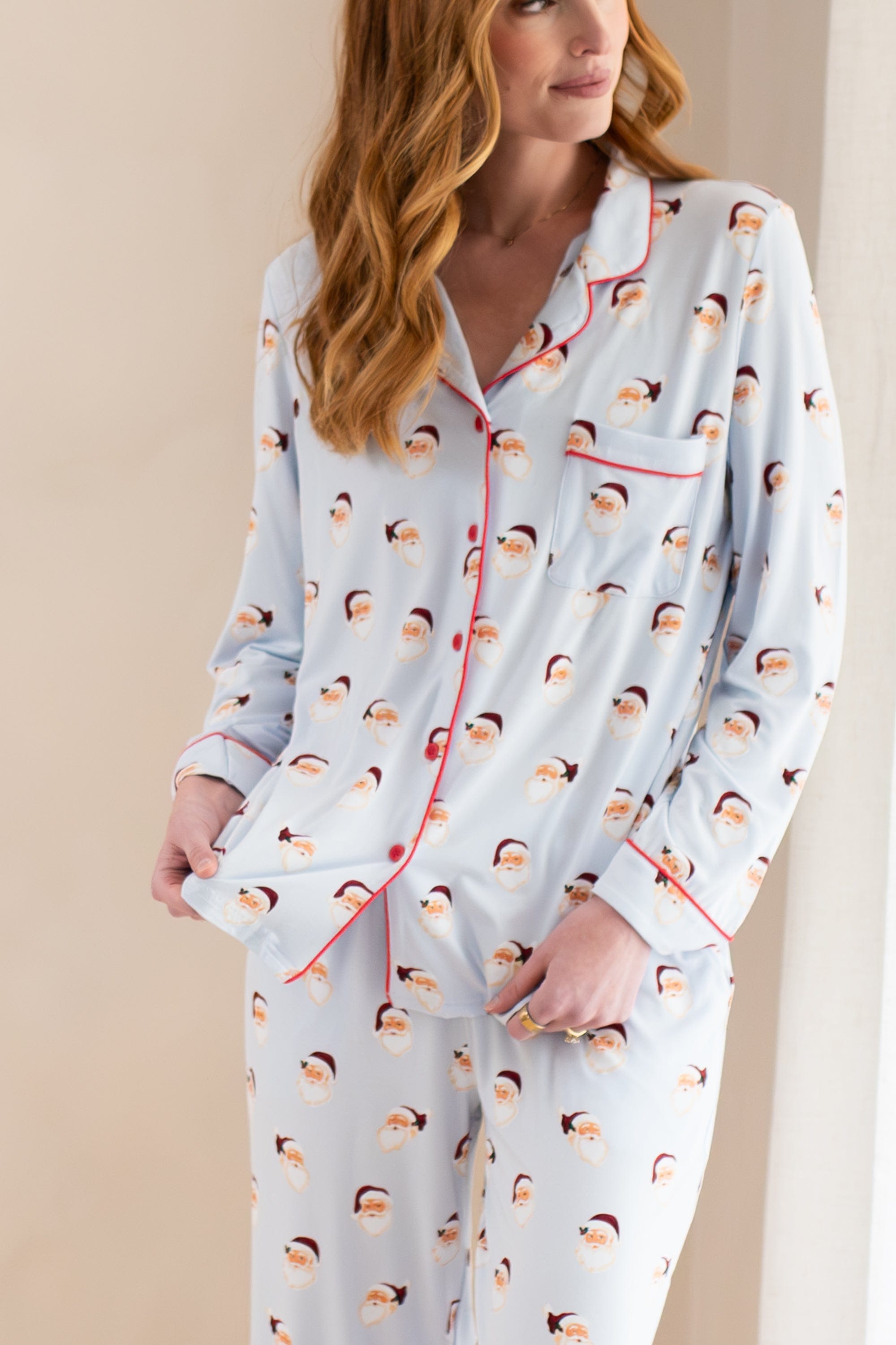 Close up of the button closure and chest pocket on the shirt of the Long-Sleeved Women's Pajama Set in Vintage Santa
