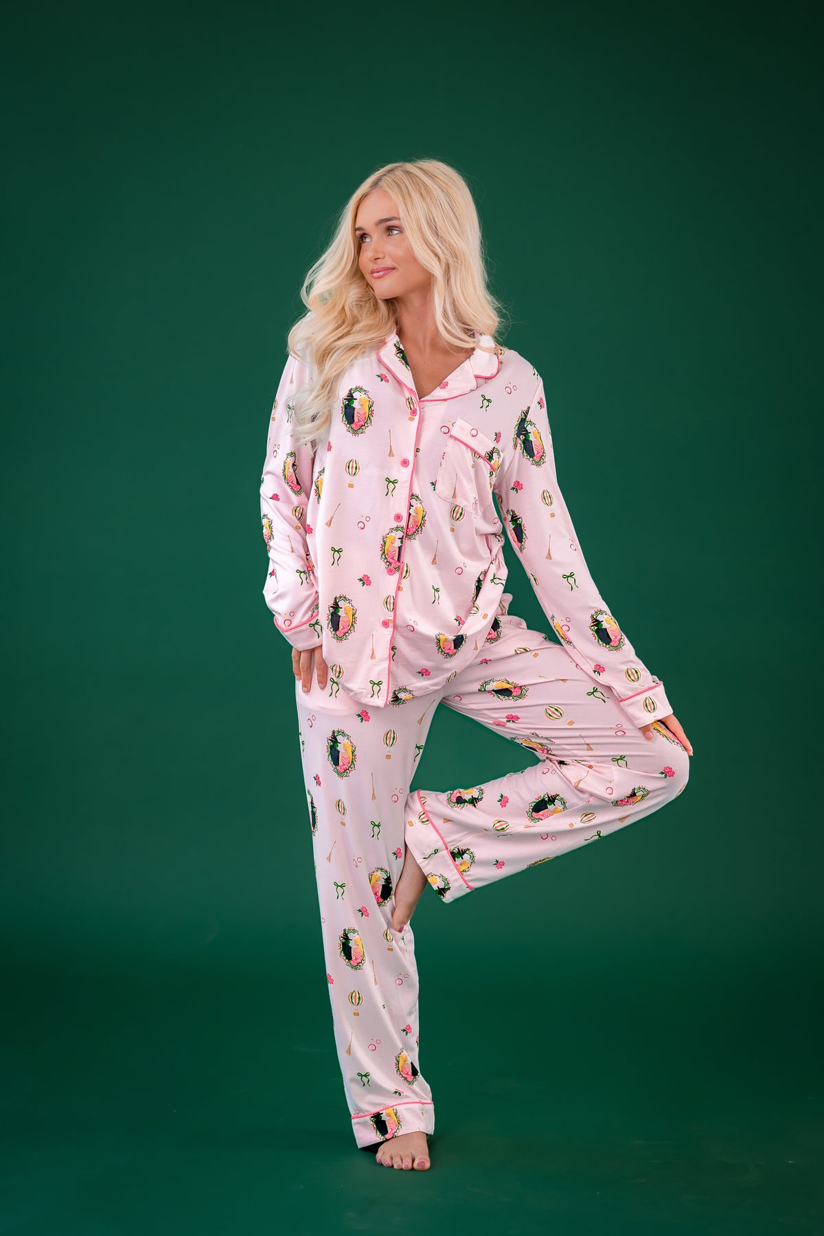 Female posing in front of a forest green background wearing the Long-Sleeved Women's Pajama Set in Wicked