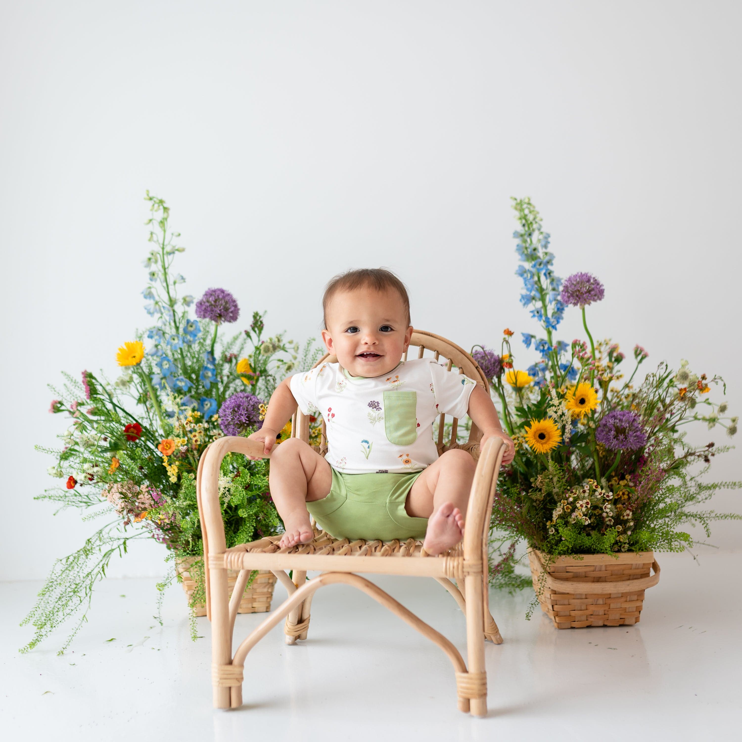 Toddler wearing Toddler Crew Neck Tee in Wildflower and Honu Bummies sitting in wooden chair