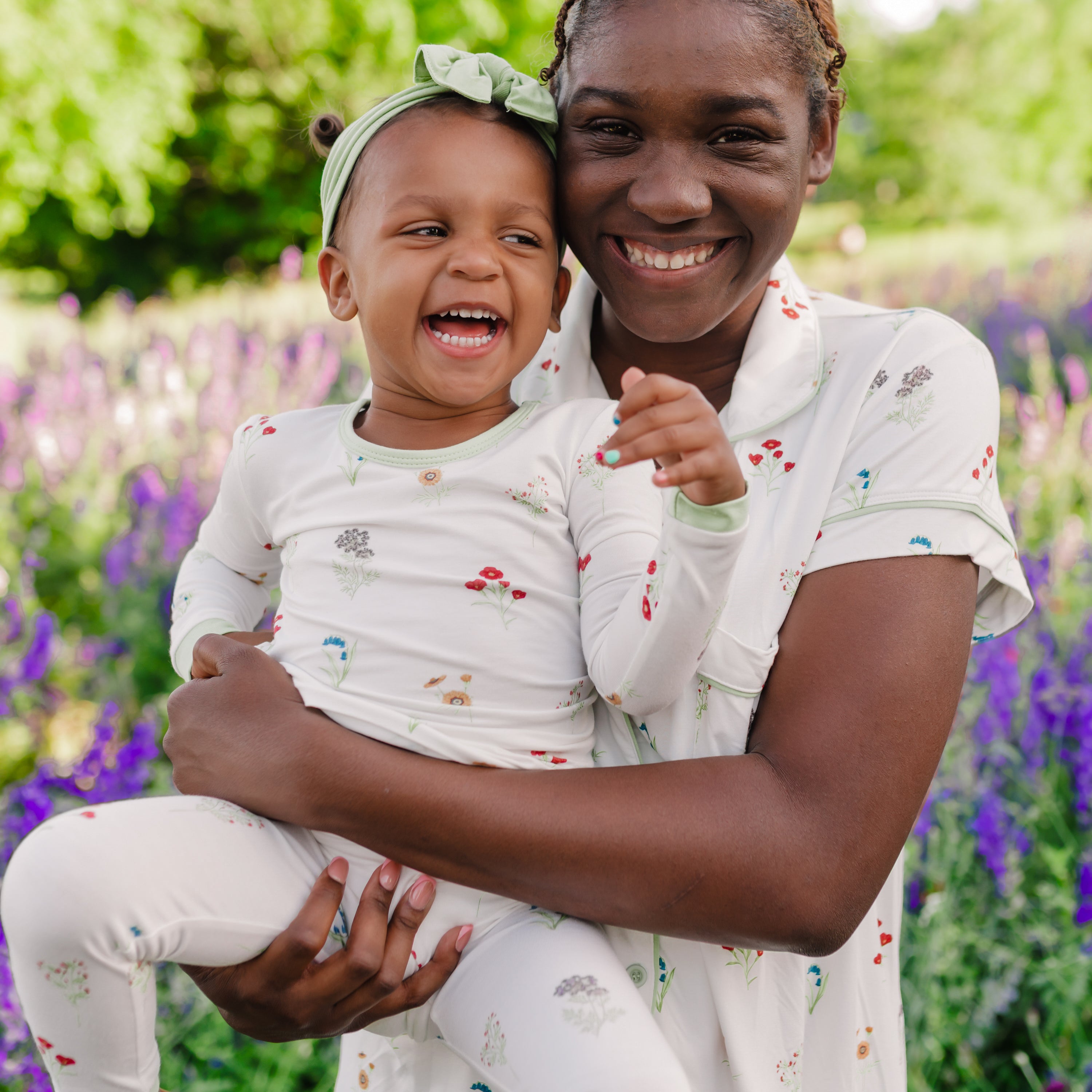 Close up of toddler in Long Sleeve Pajamas in Wildflower being held by mom