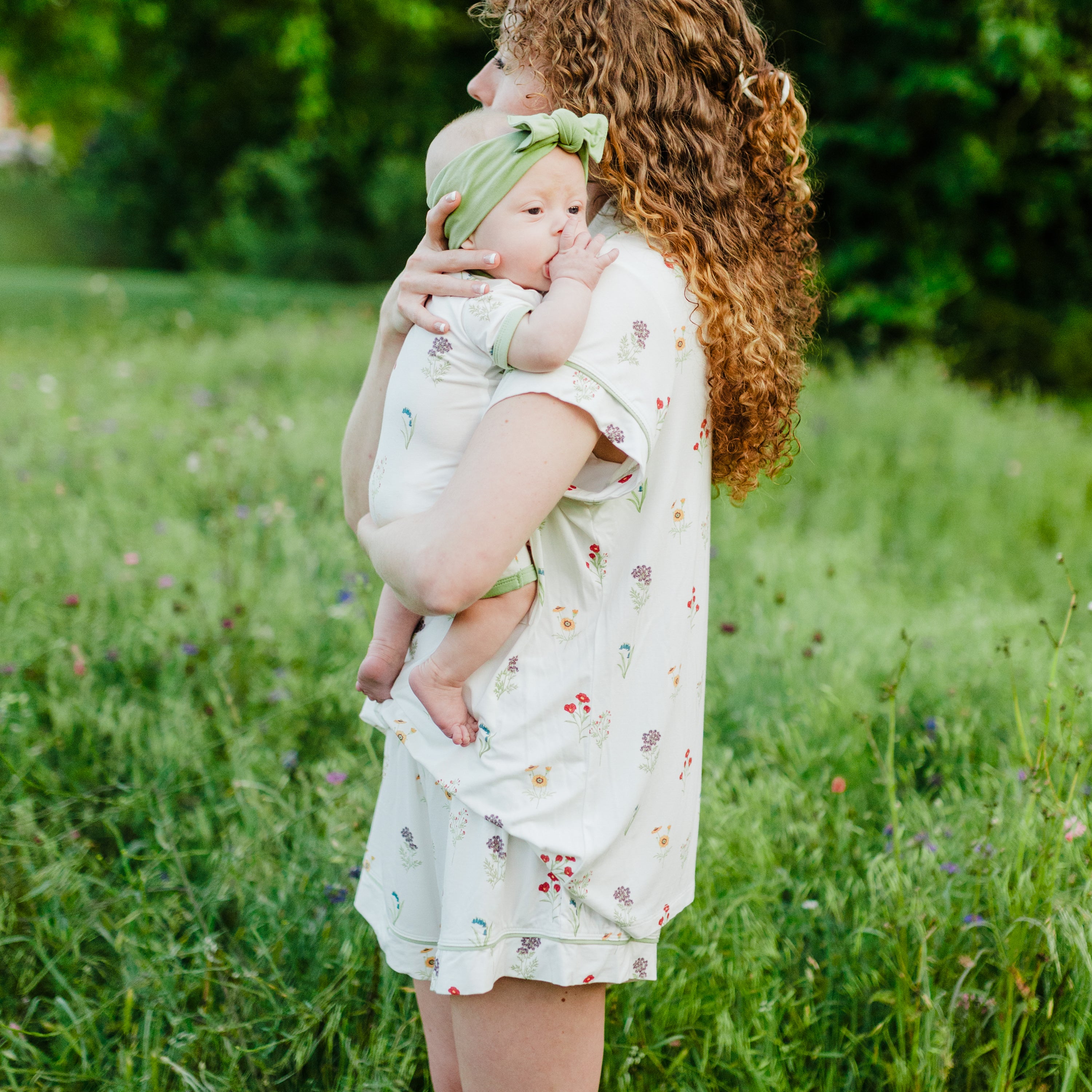 Woman modeling Women’s Short Sleeve Pajama Set in Wildflower while holding baby side view