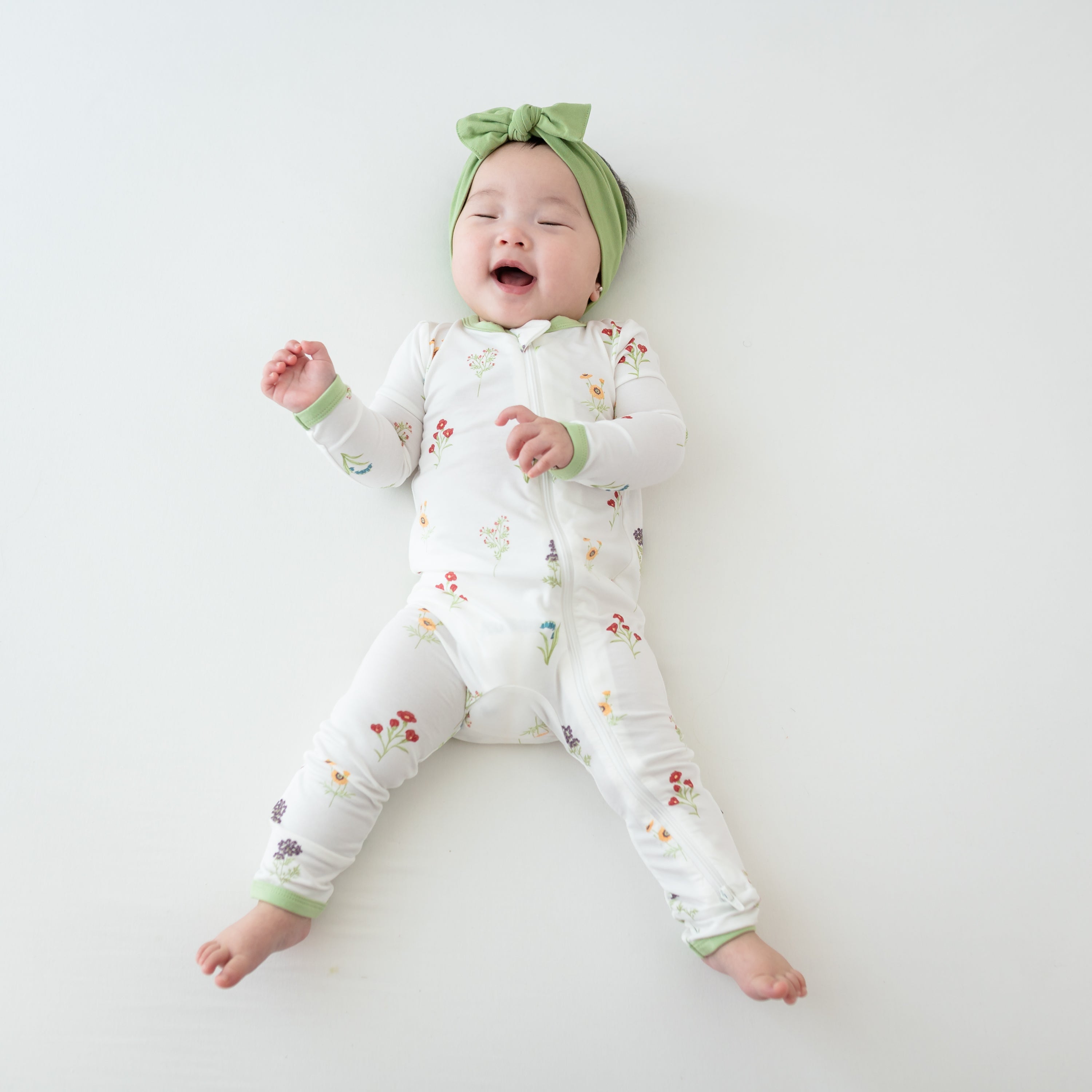 Baby in Zippered Romper in Wildflower and Honu Headband Bow