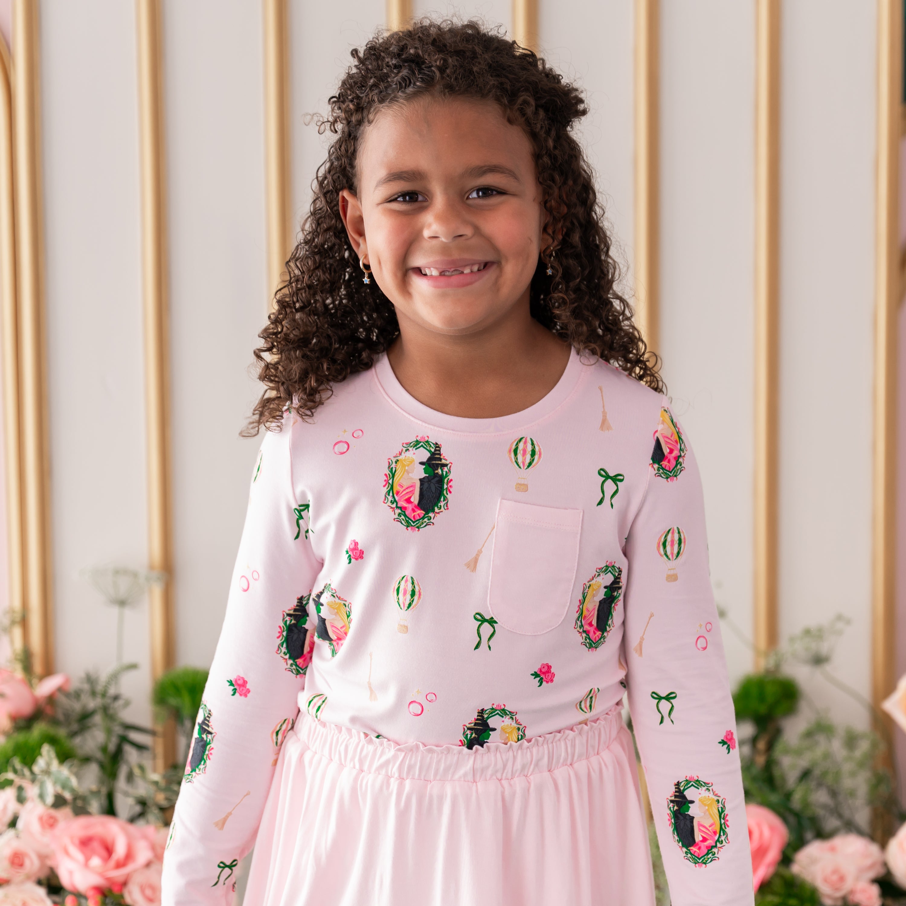 Close up of young girl wearing the Long Sleeve Toddler Crew Neck Tee in Wicked with Sakura skort