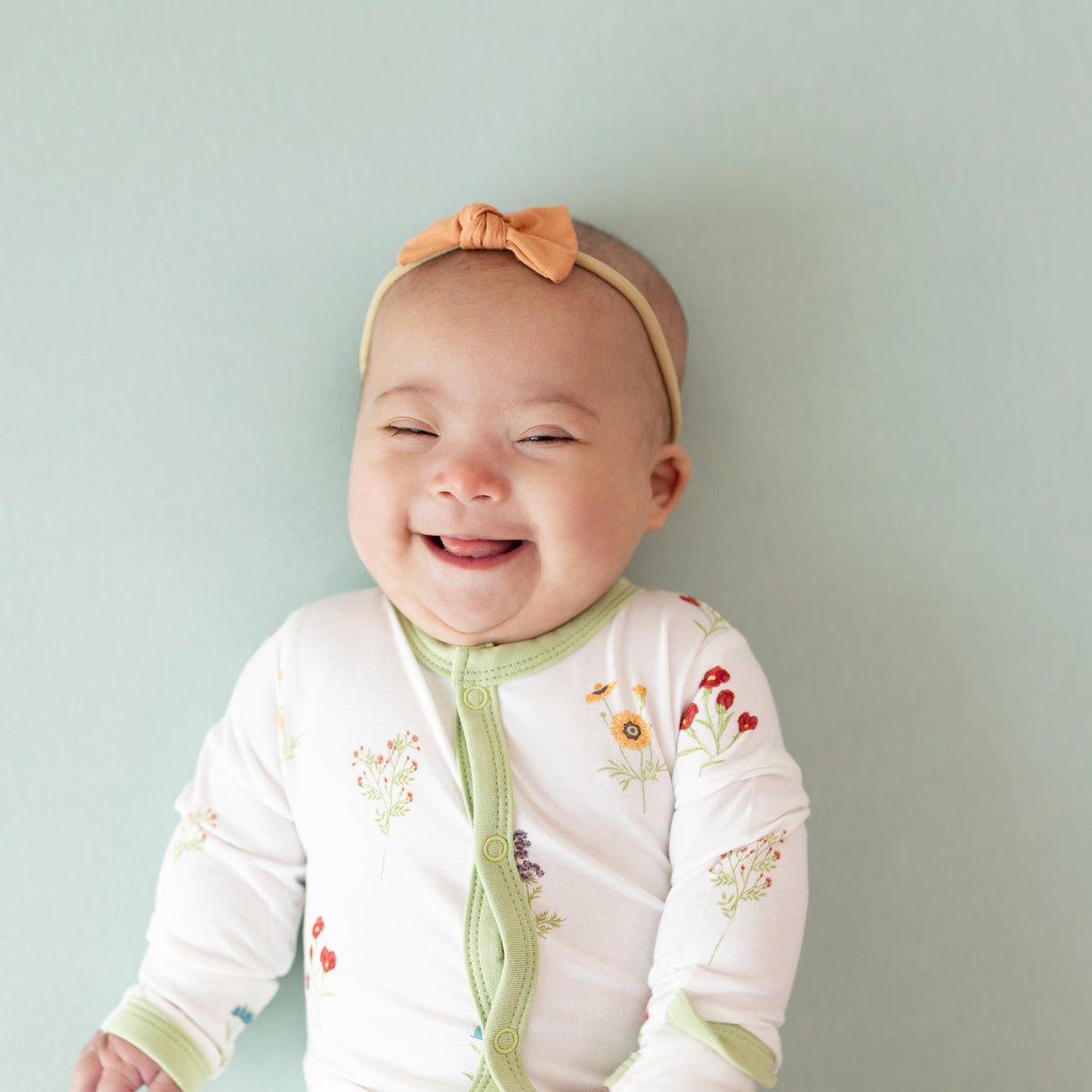 Baby wearing snap pajamas in Wildflower